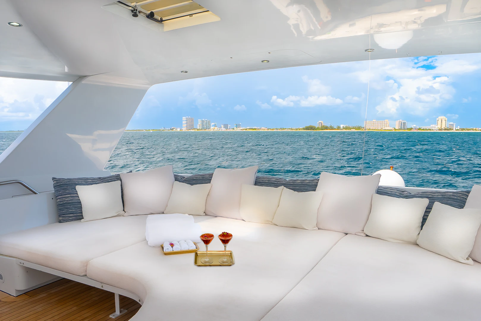 a white couch with a white sofa and a large body of water aboard GALE WINDS Yacht for Charter