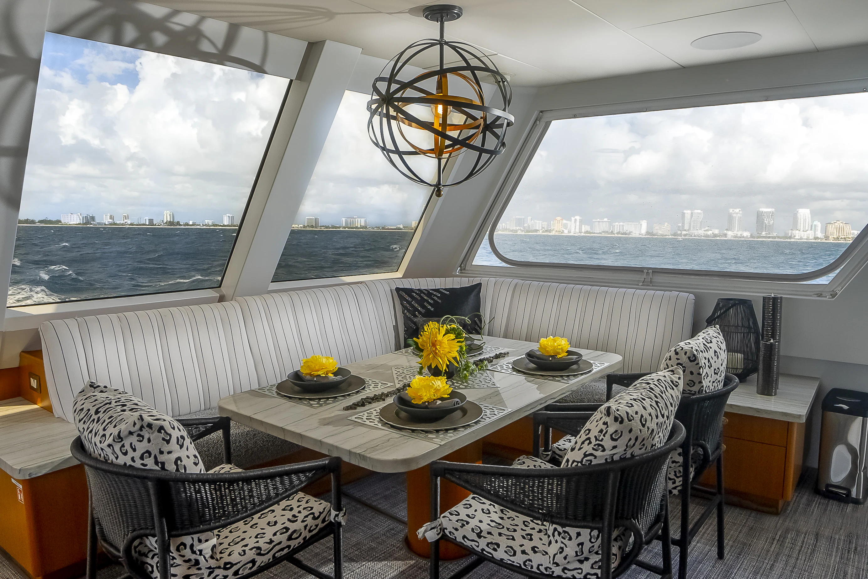a room with a table chairs and a large window aboard GALE WINDS Yacht for Charter