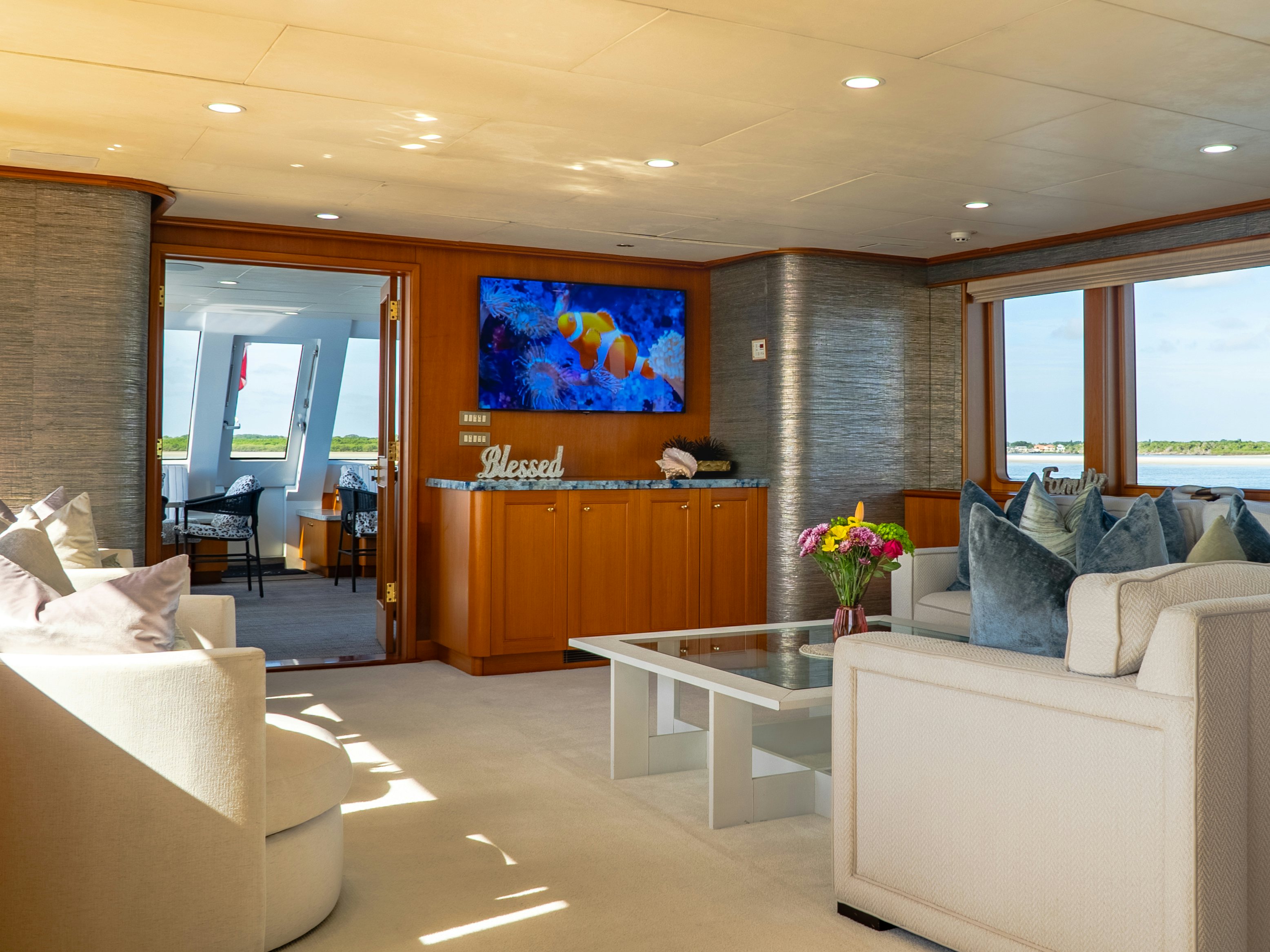 a living room with a large screen aboard GALE WINDS Yacht for Sale