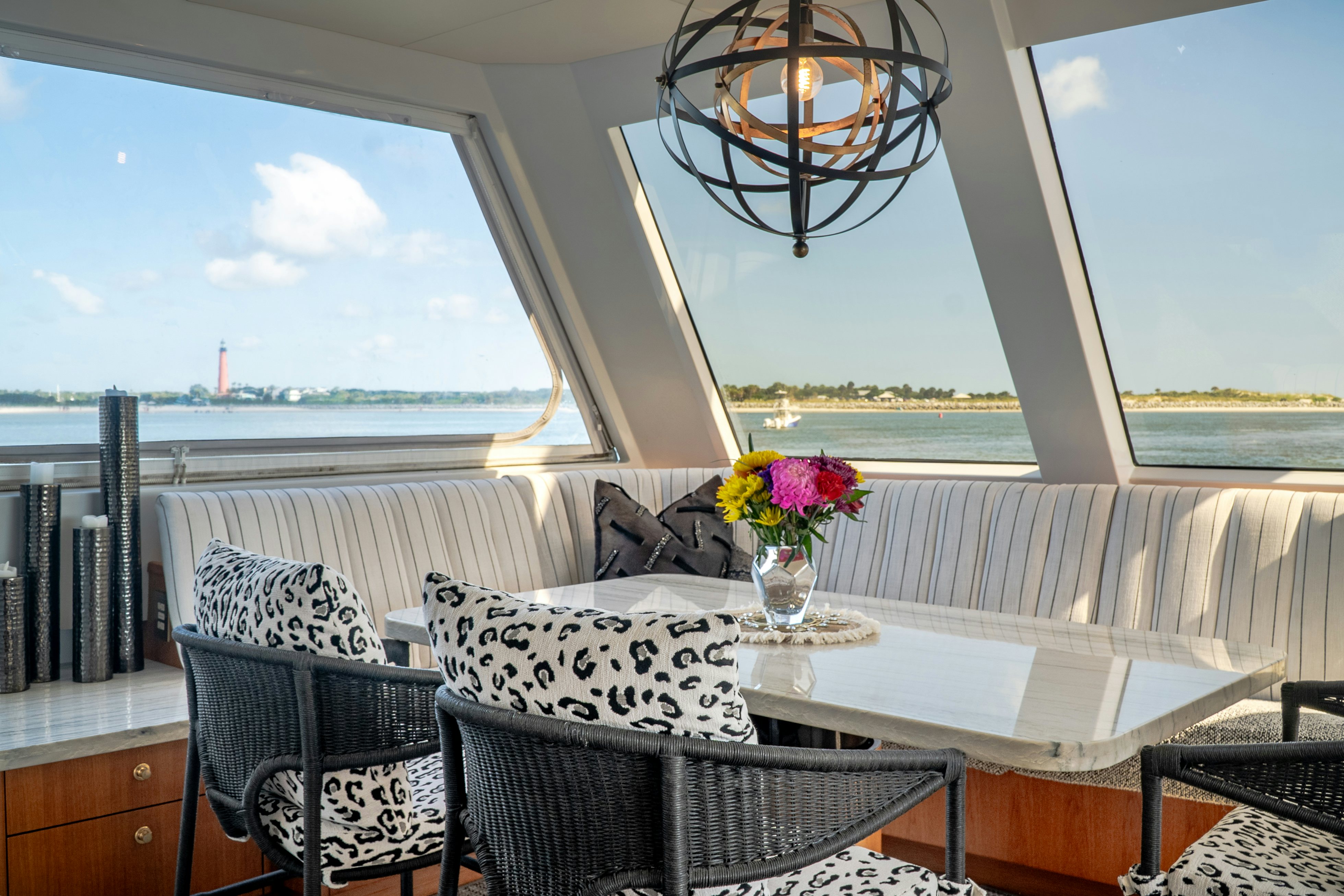 a table with chairs and a view of the city aboard GALE WINDS Yacht for Sale