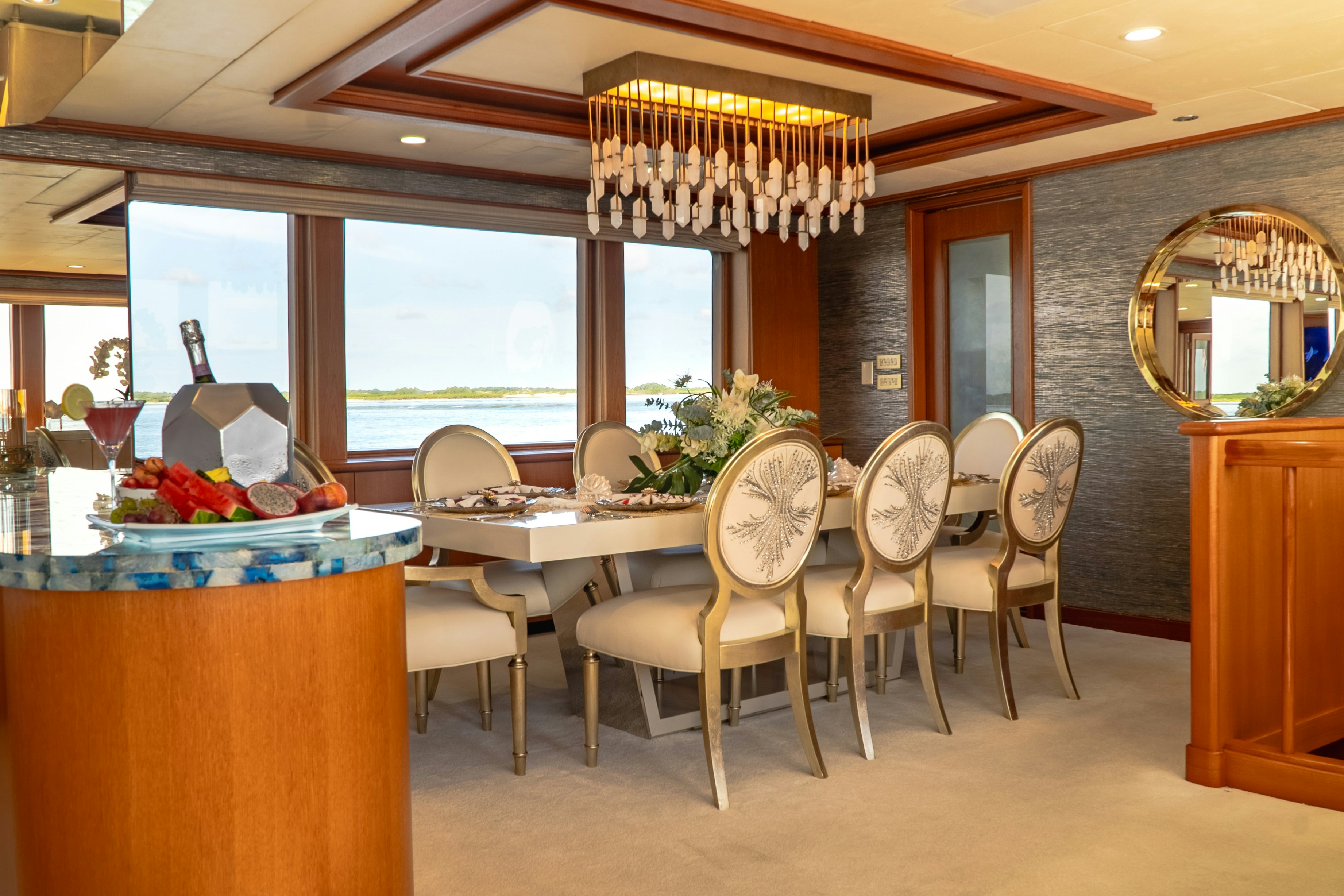 a room with a table chairs and a mirror aboard GALE WINDS Yacht for Sale
