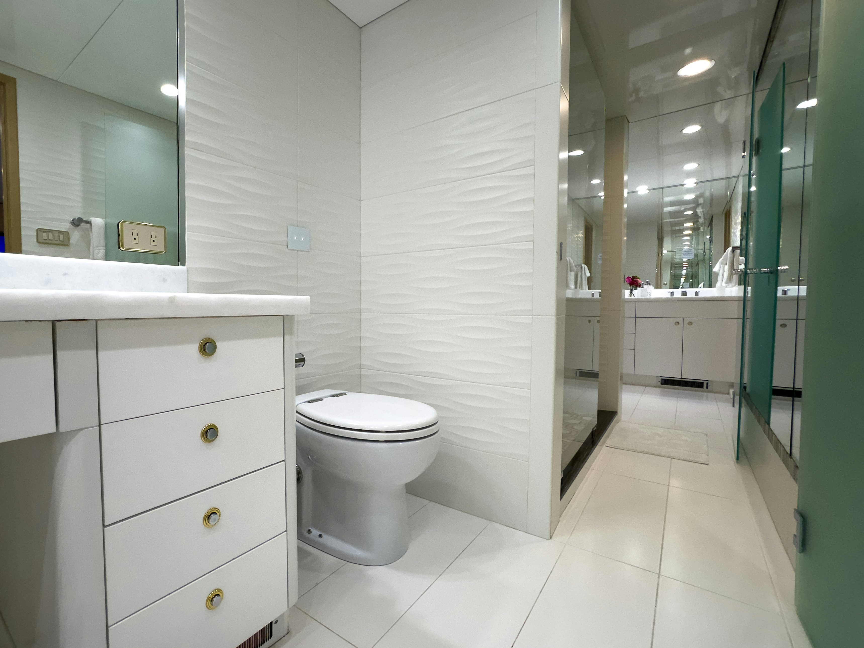 a bathroom with a toilet and a mirror aboard GALE WINDS Yacht for Sale