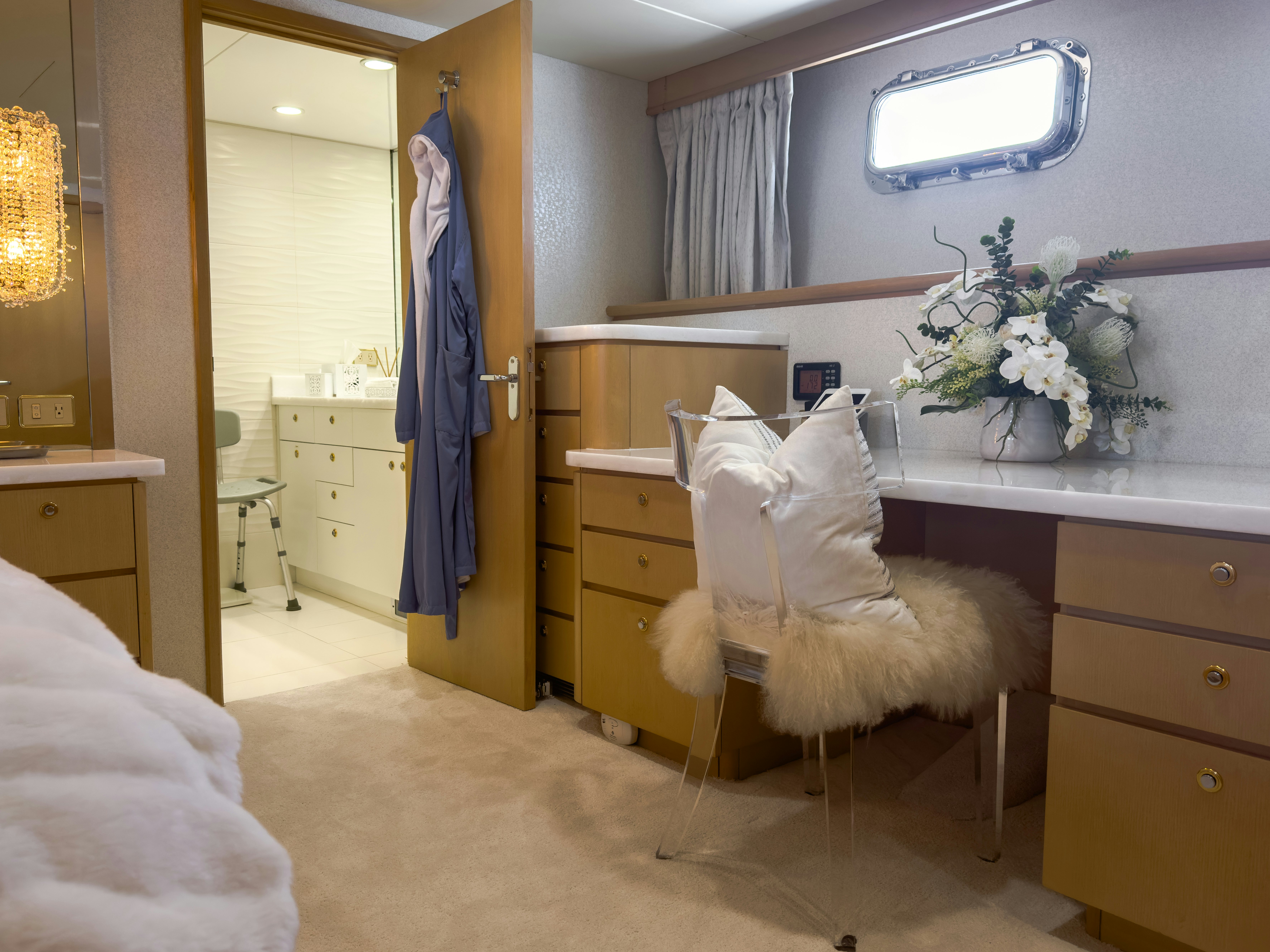 a bedroom with a blue curtain aboard GALE WINDS Yacht for Sale