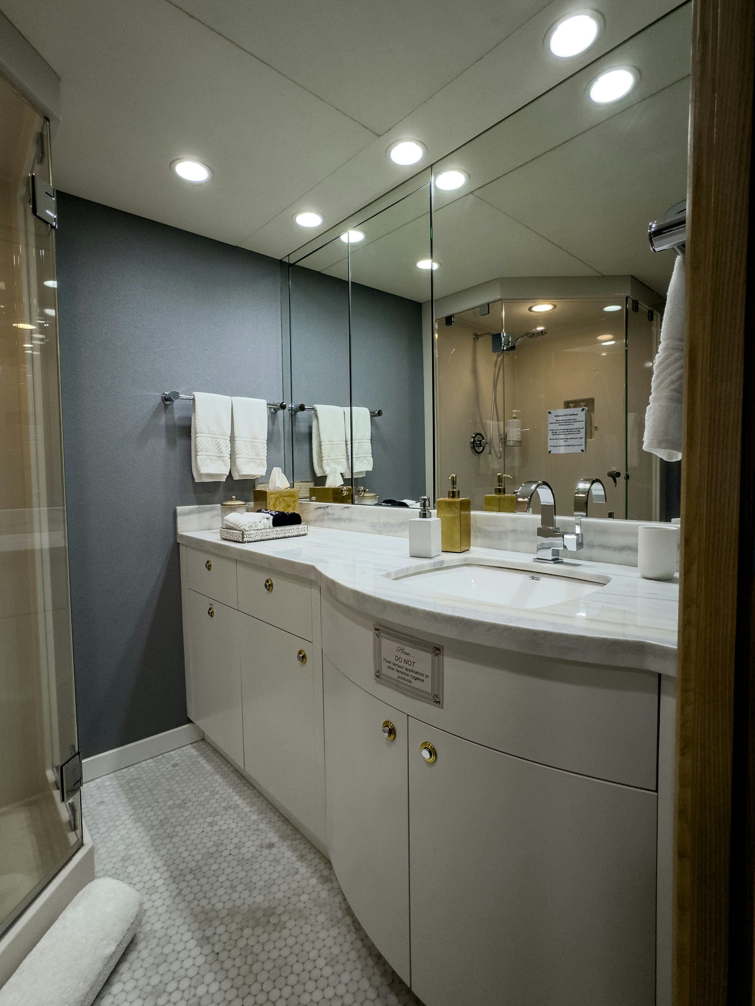 a bathroom with a large mirror aboard GALE WINDS Yacht for Sale