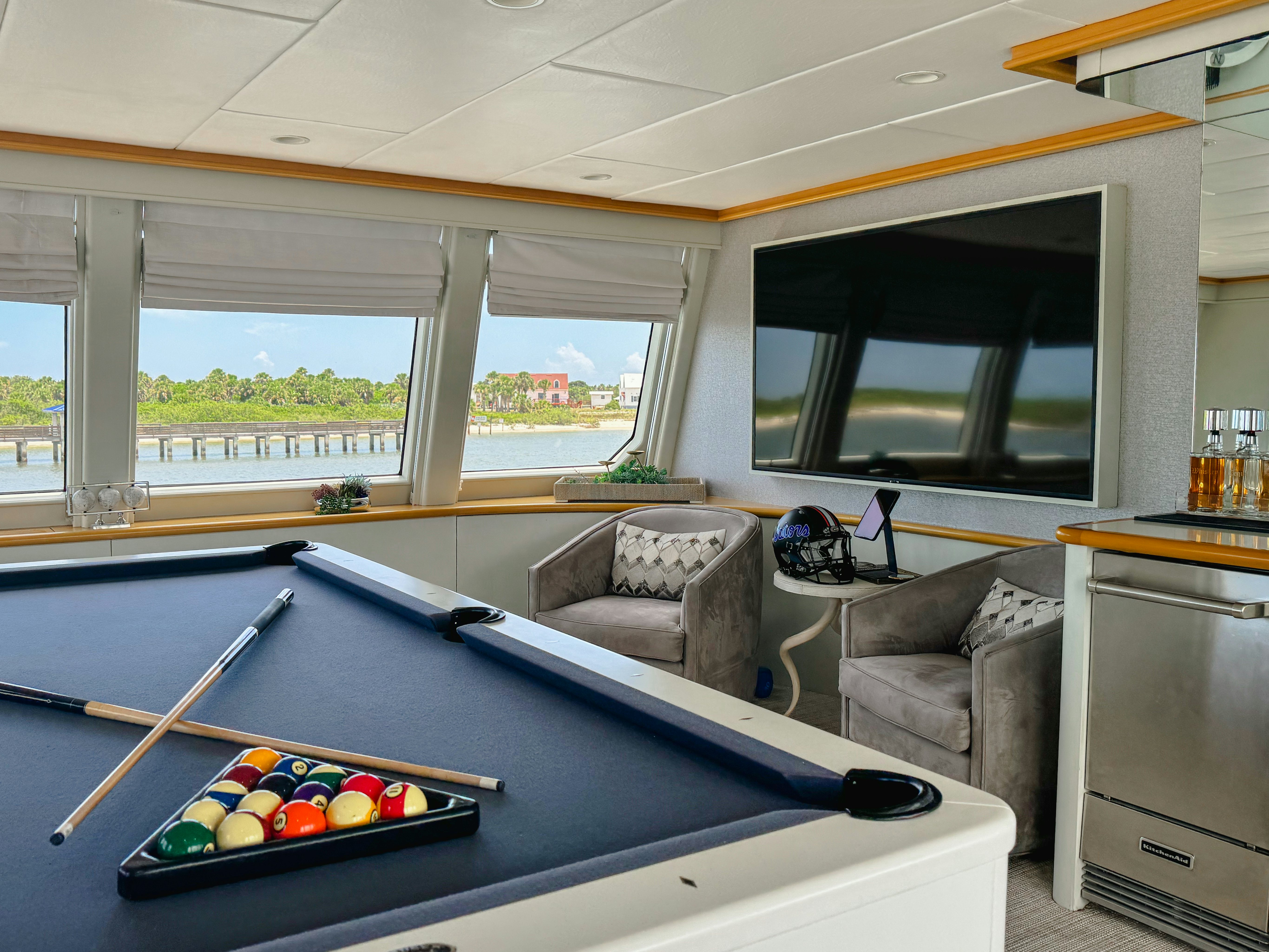 a living room with a couch and a pool table aboard GALE WINDS Yacht for Sale