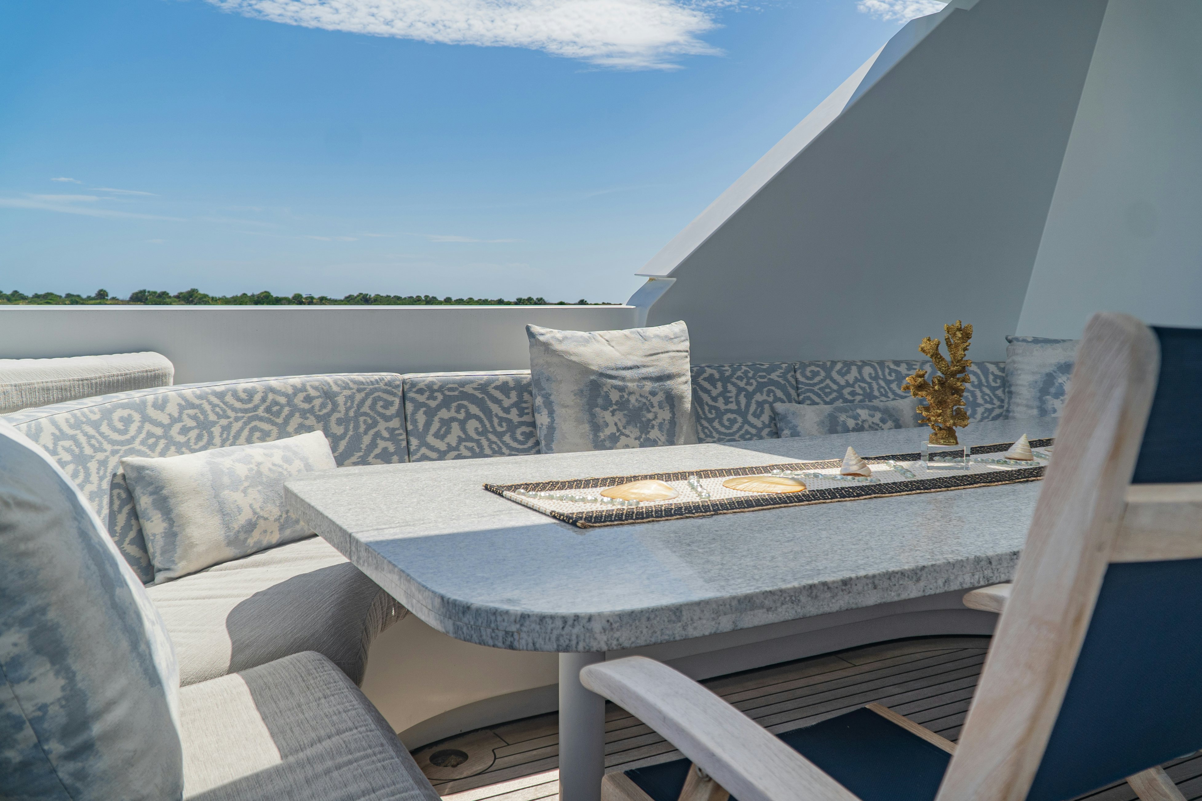 a table with chairs and a couch aboard GALE WINDS Yacht for Sale