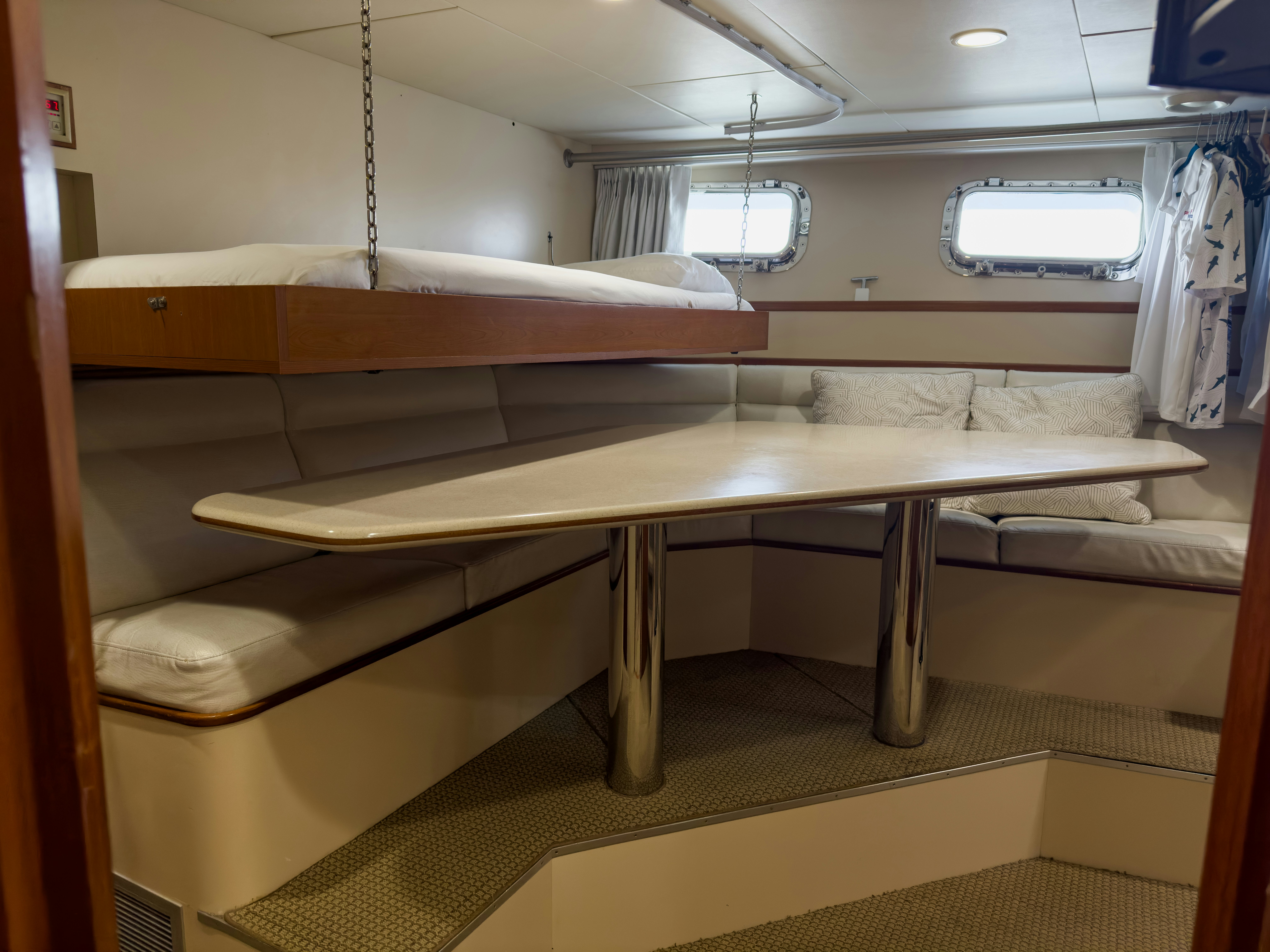 a room with a table and a bench aboard GALE WINDS Yacht for Sale