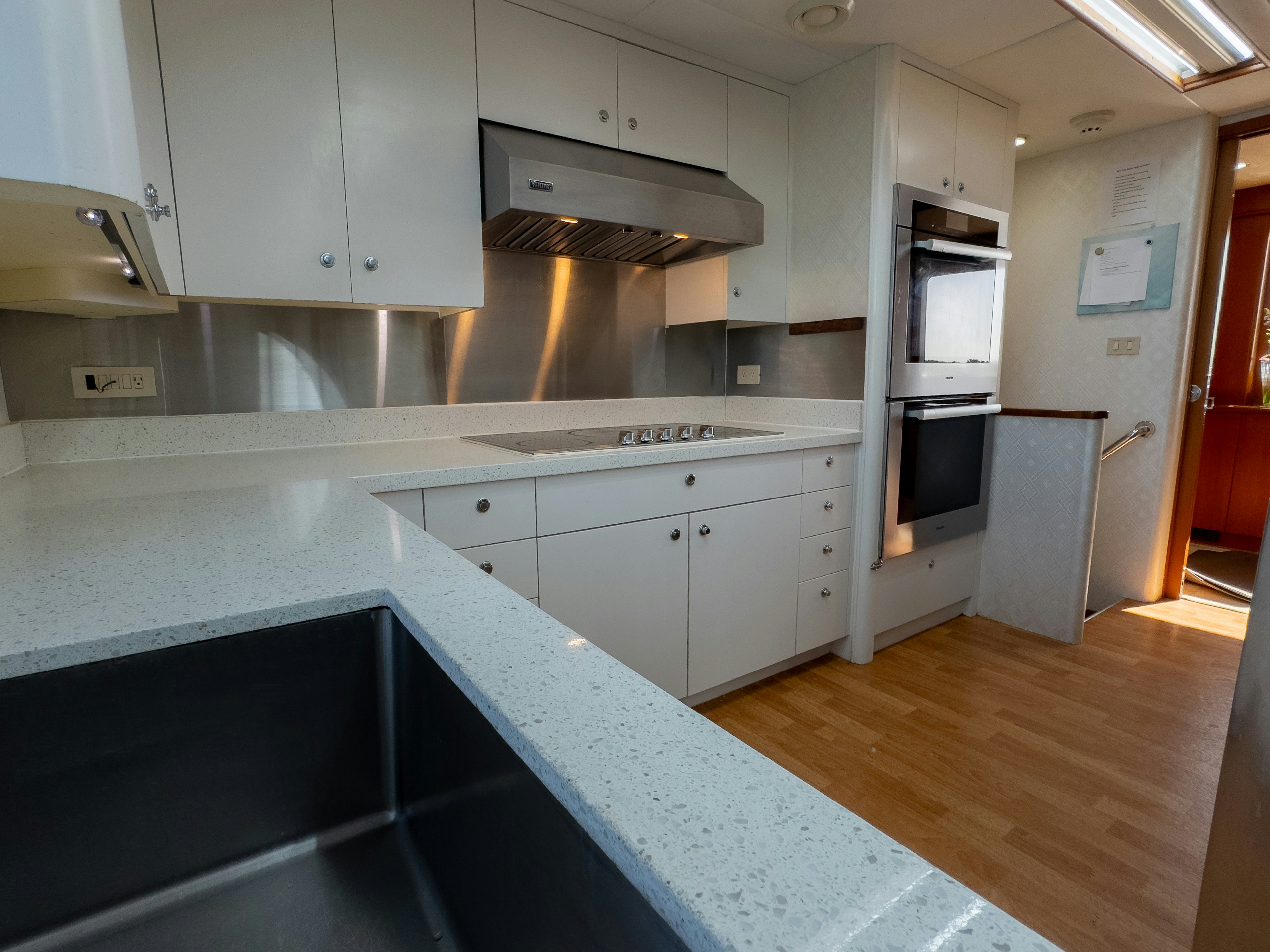 a kitchen with white cabinets aboard GALE WINDS Yacht for Sale