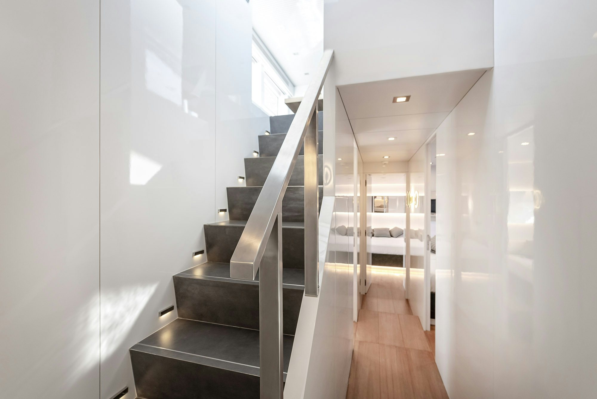 a long hallway with glass doors aboard IGUAZU Yacht for Sale