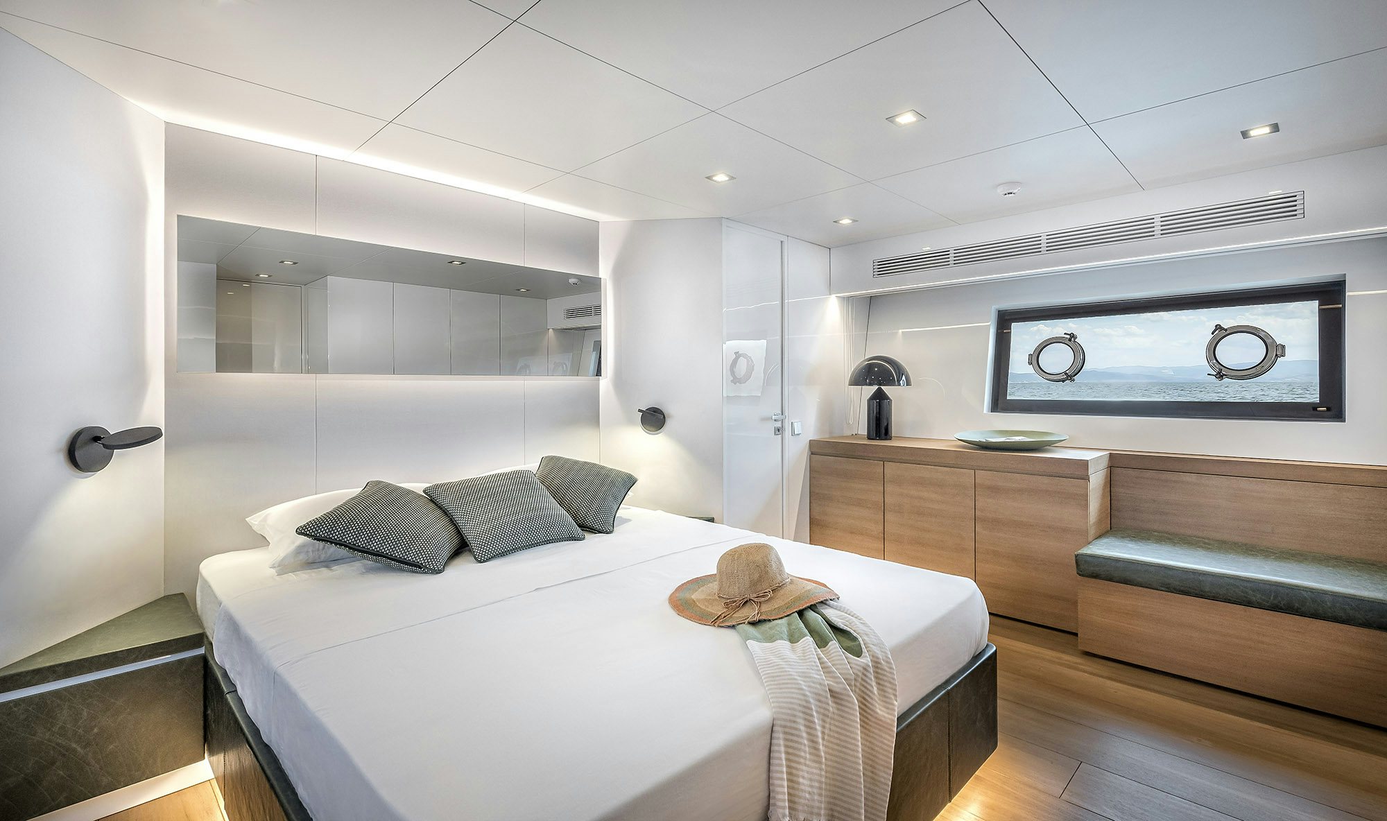 a room with a bed and a table aboard IGUAZU Yacht for Sale