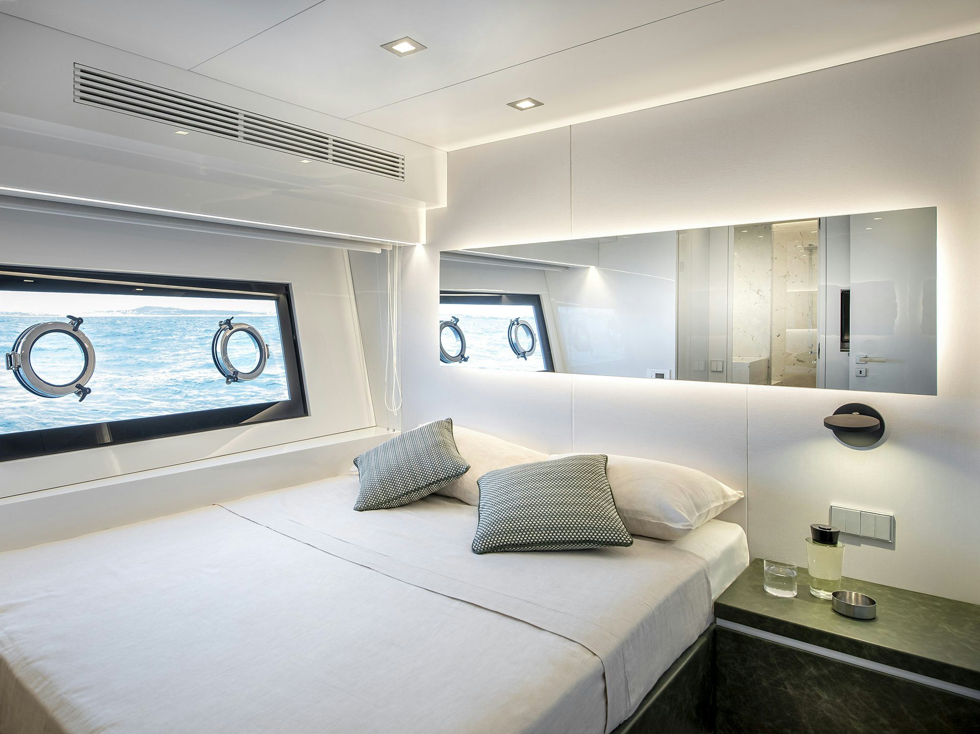 a room with a bed and a table aboard IGUAZU Yacht for Sale