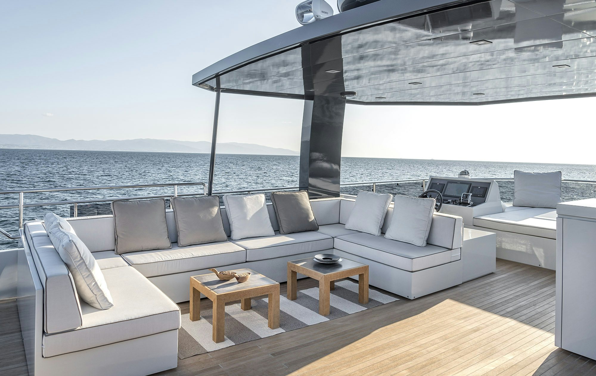 a living room with a large window overlooking the ocean aboard IGUAZU Yacht for Sale