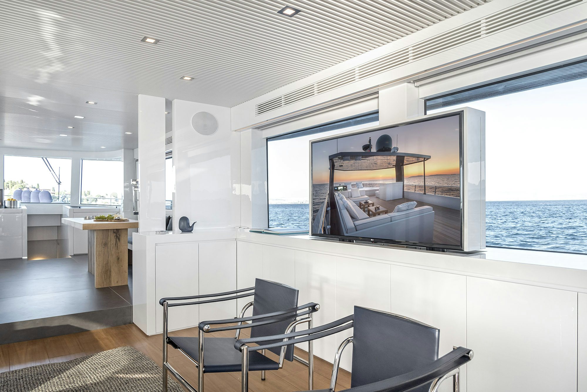 a room with a television and a chair aboard IGUAZU Yacht for Sale