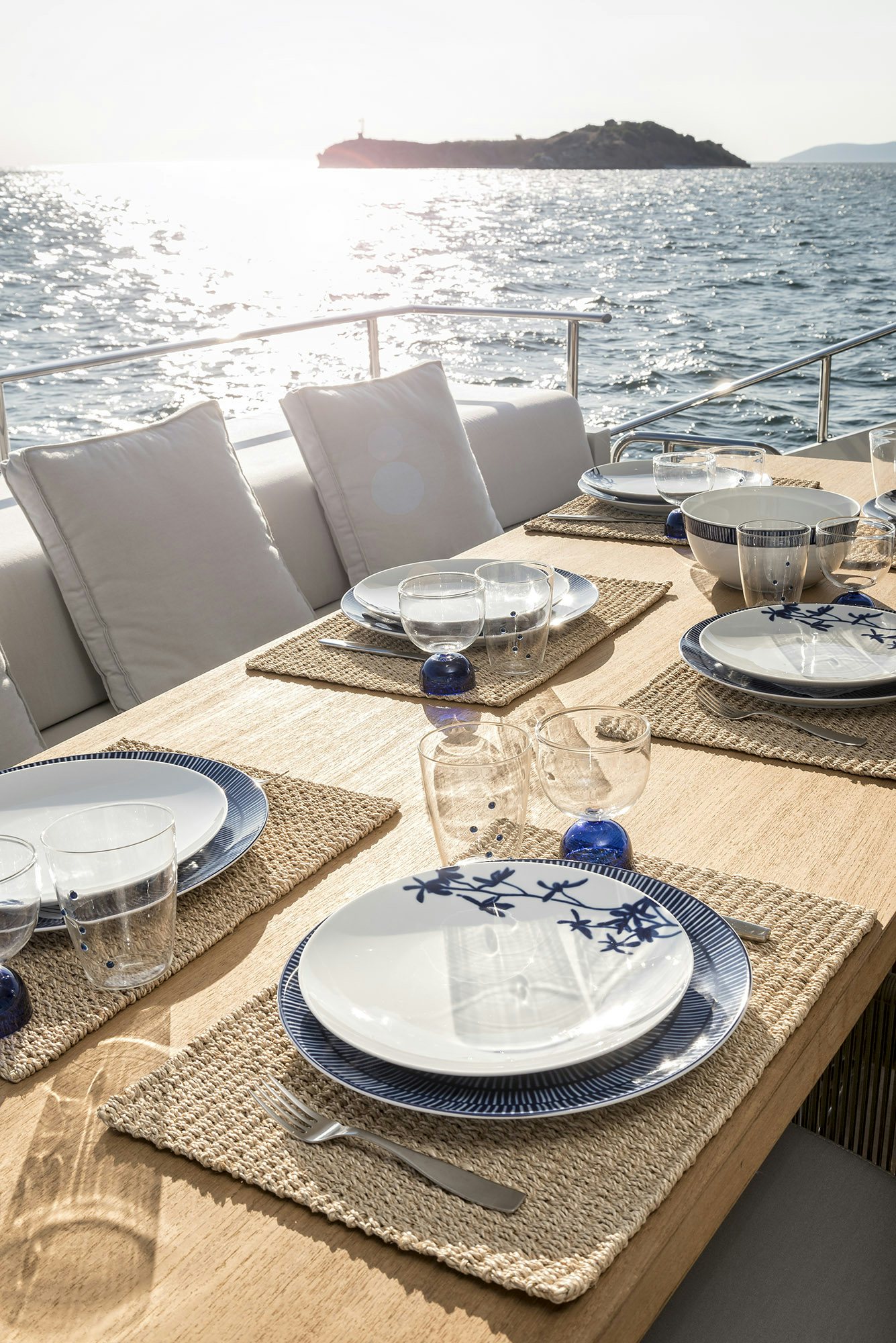 a table with plates and glasses on it aboard IGUAZU Yacht for Sale