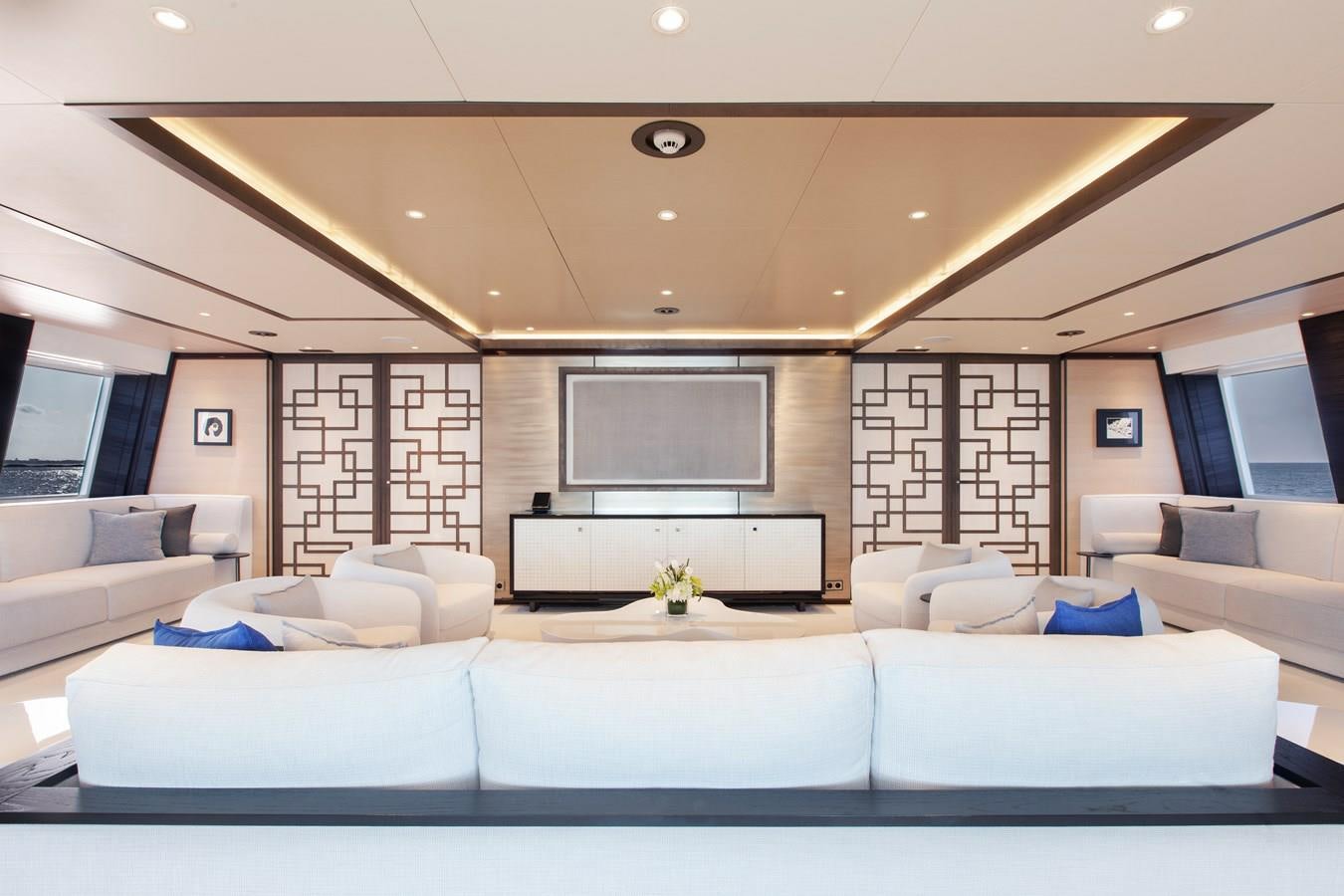 a living room with white couches aboard SAMURAI Yacht for Sale