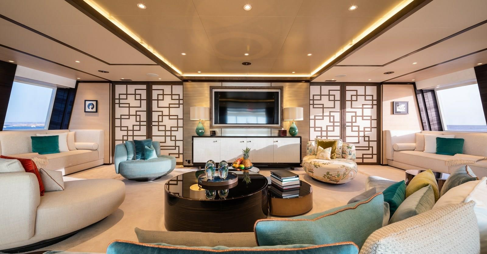 a living room with a large screen aboard SAMURAI Yacht for Sale