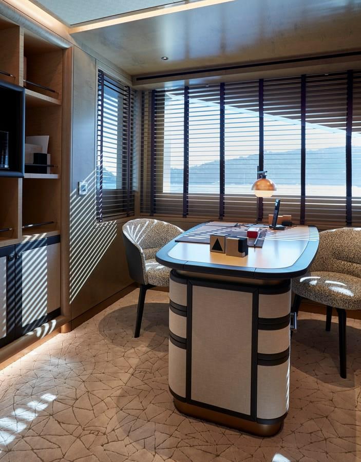 a table and chairs in a room aboard SOMNIUM Yacht for Sale
