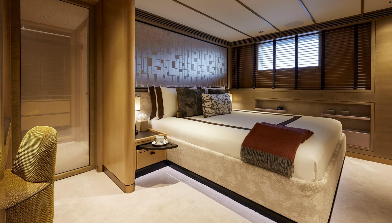 a room with a bed and a desk aboard SOMNIUM Yacht for Sale