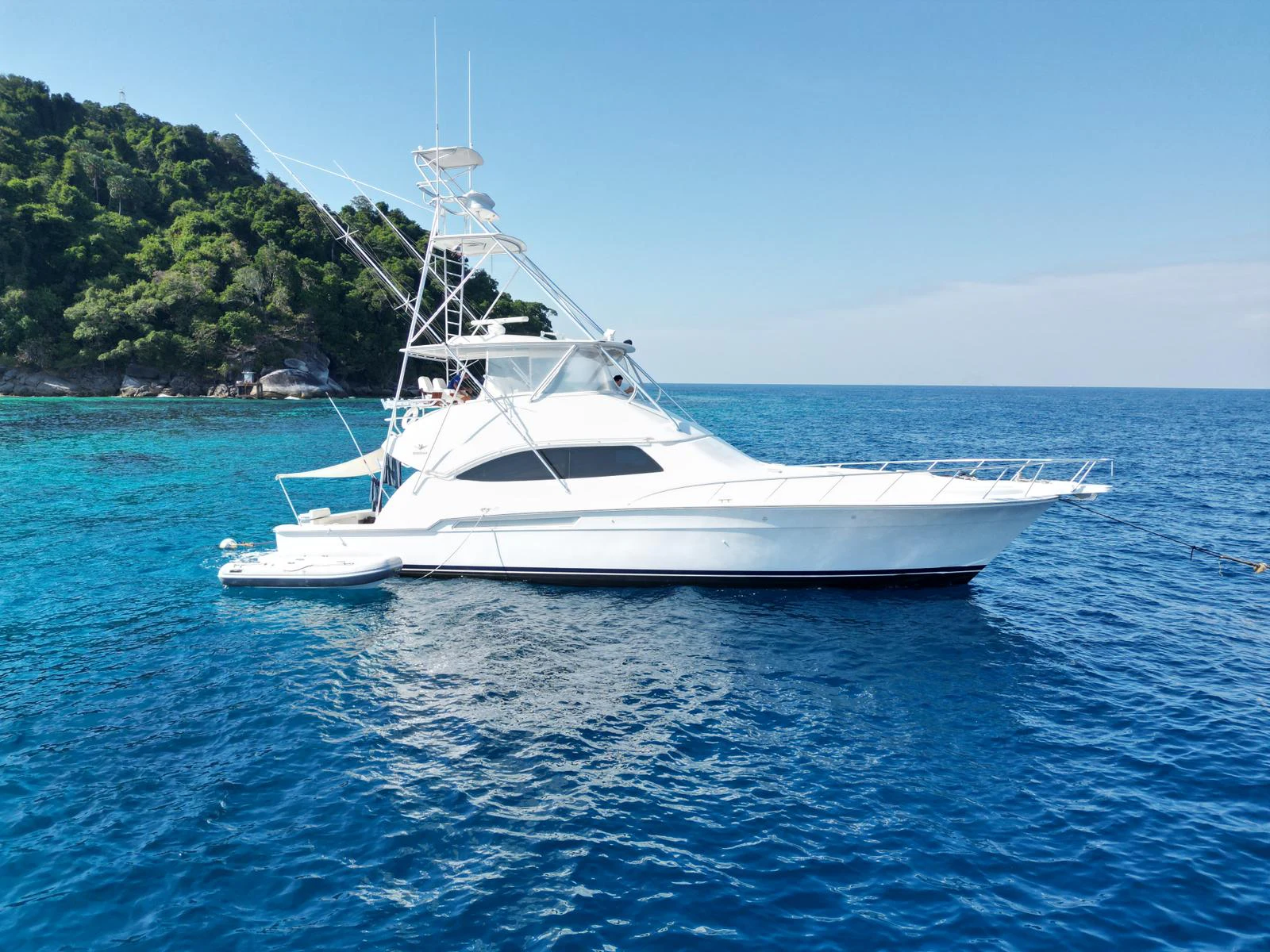 a white boat on the water aboard ISAKINDOFMAGIC Yacht for Sale