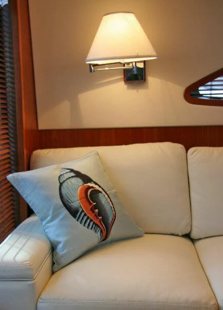 a couch with pillows aboard ISAKINDOFMAGIC Yacht for Sale