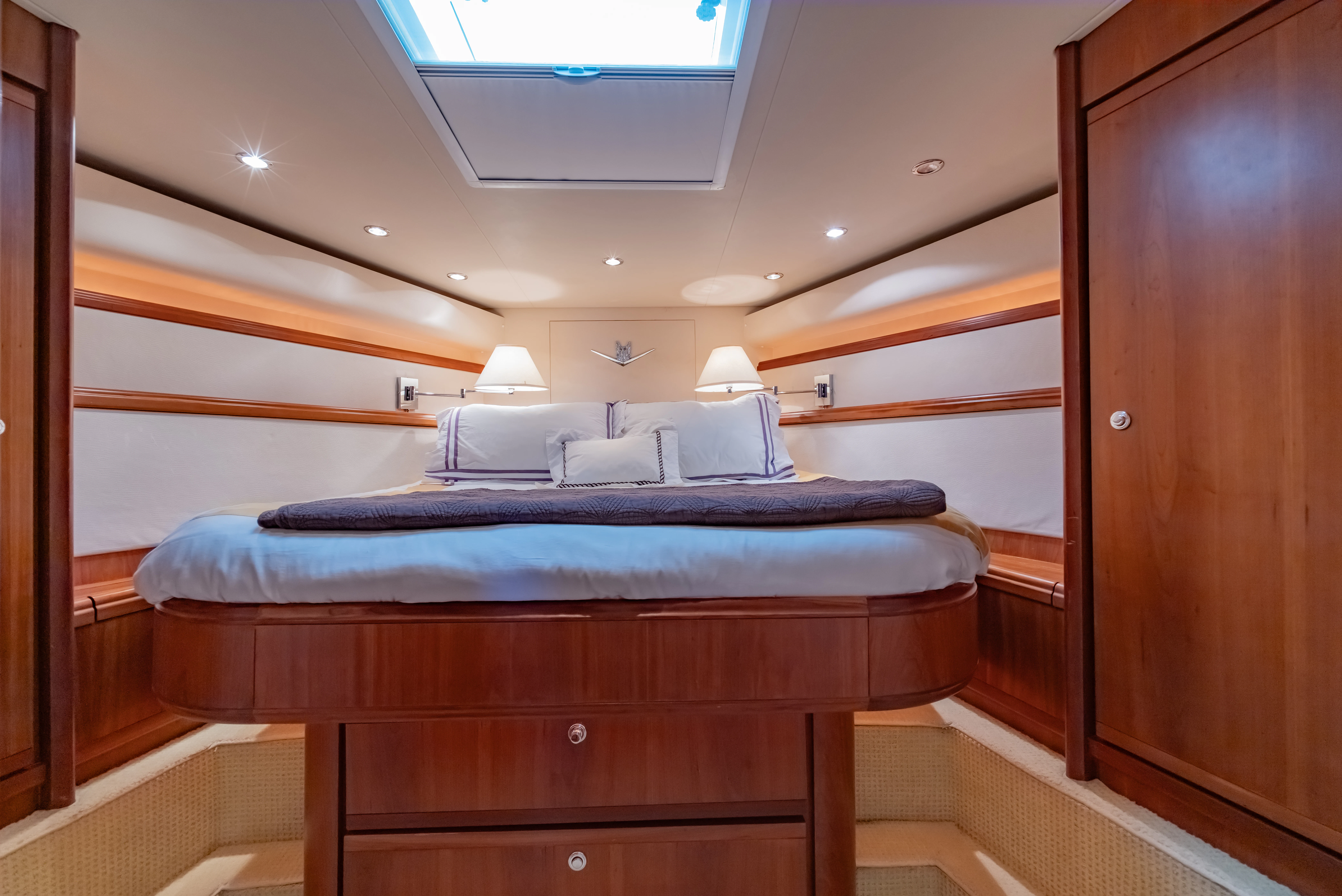 a bed with a blue sheet aboard ISAKINDOFMAGIC Yacht for Sale