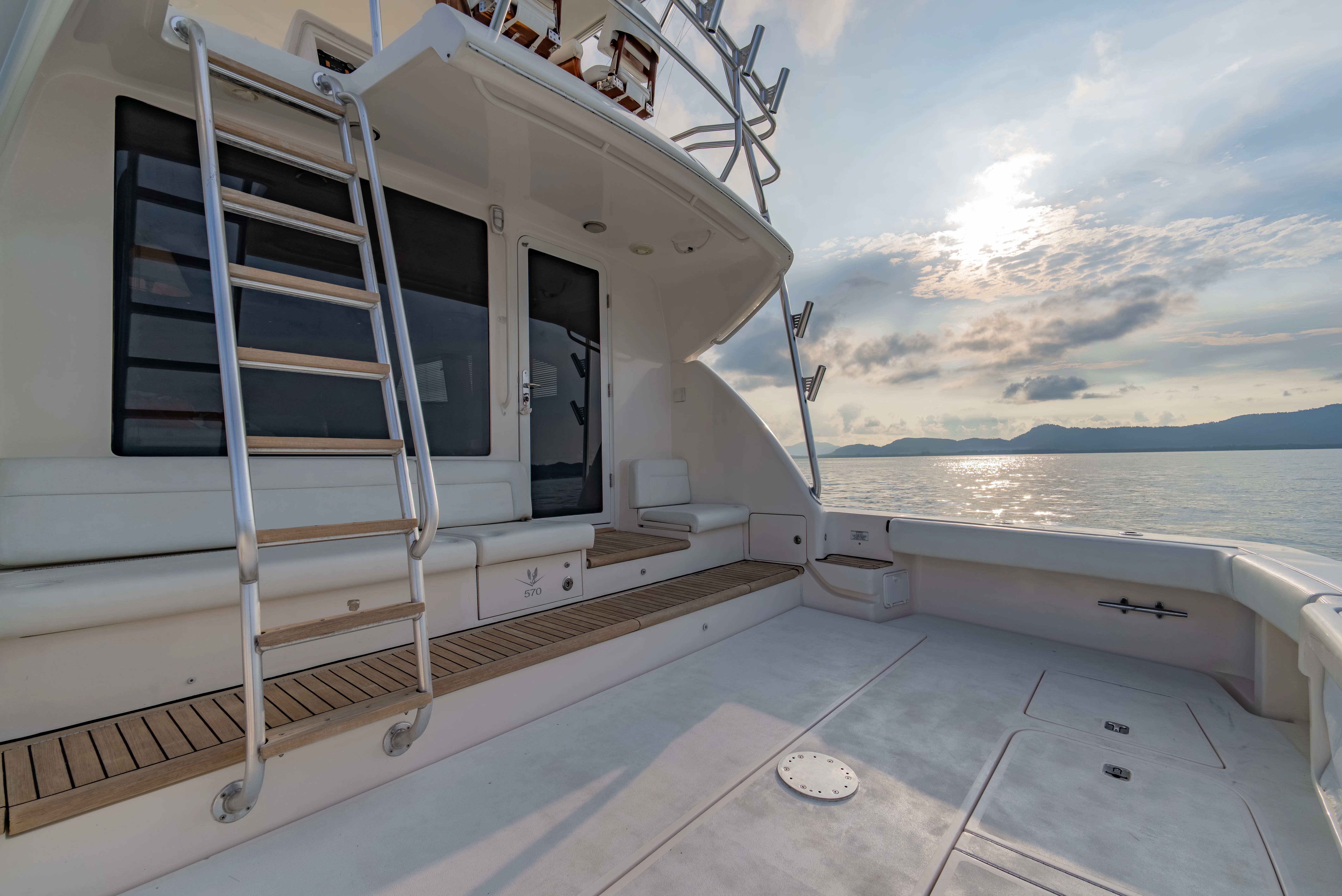 a white boat on a deck aboard ISAKINDOFMAGIC Yacht for Sale
