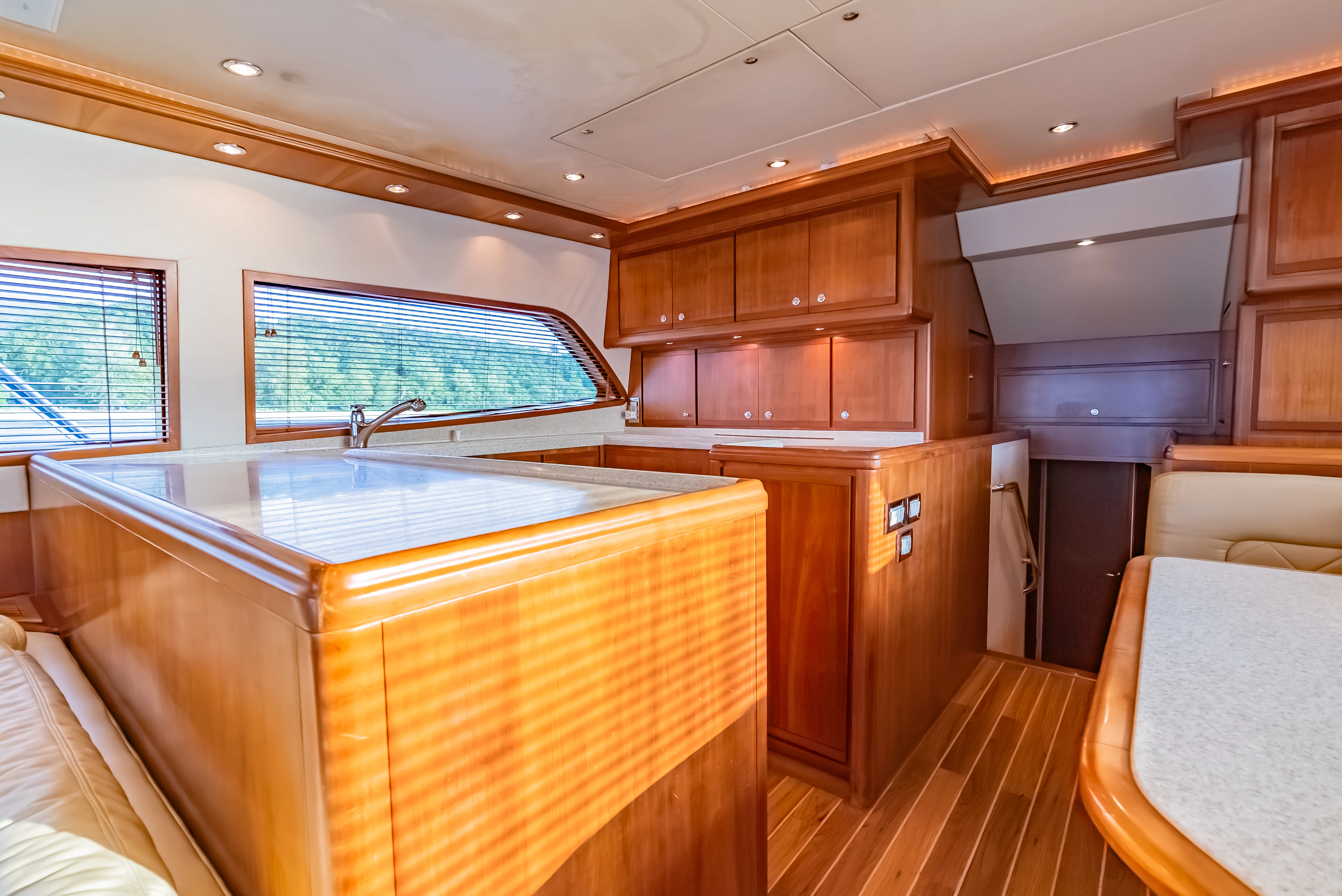 a kitchen with wooden cabinets aboard ISAKINDOFMAGIC Yacht for Sale