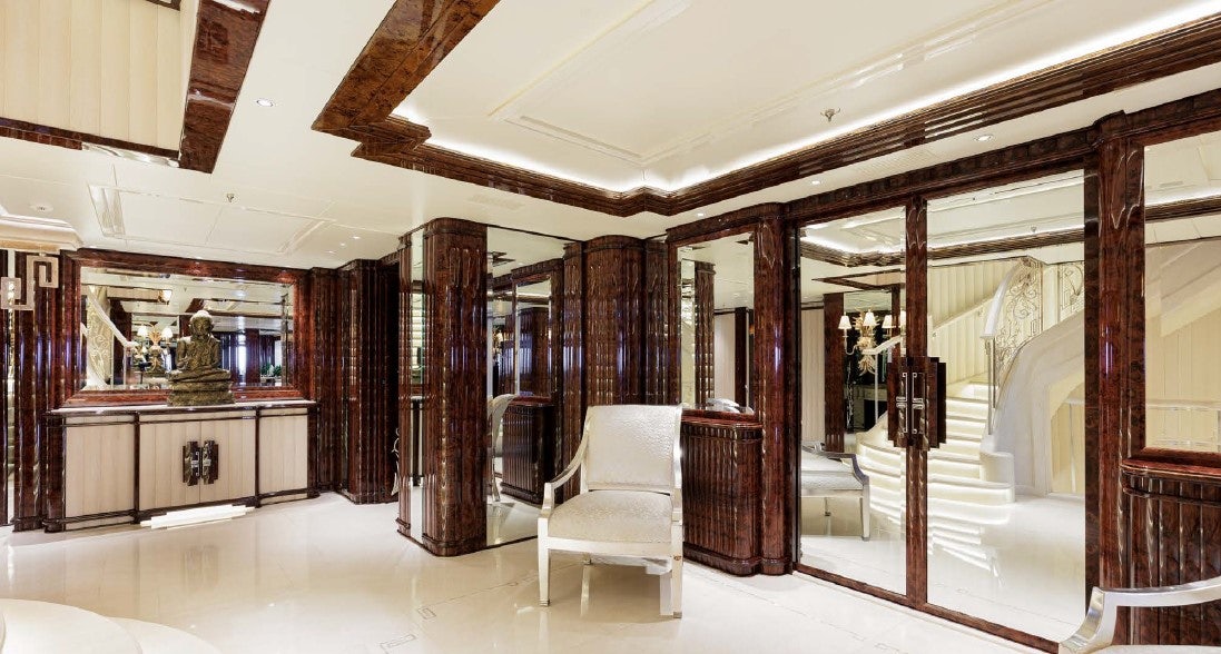 a room with a chair and a table and a mirror aboard LIONESS V Yacht for Sale