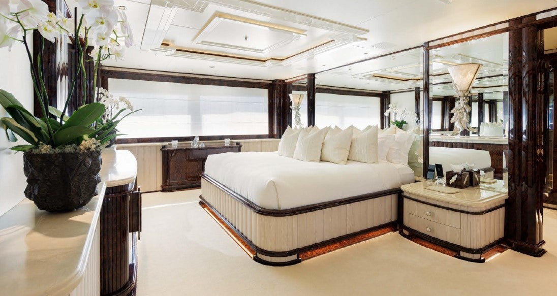 a large bedroom with a large bed aboard LIONESS V Yacht for Sale