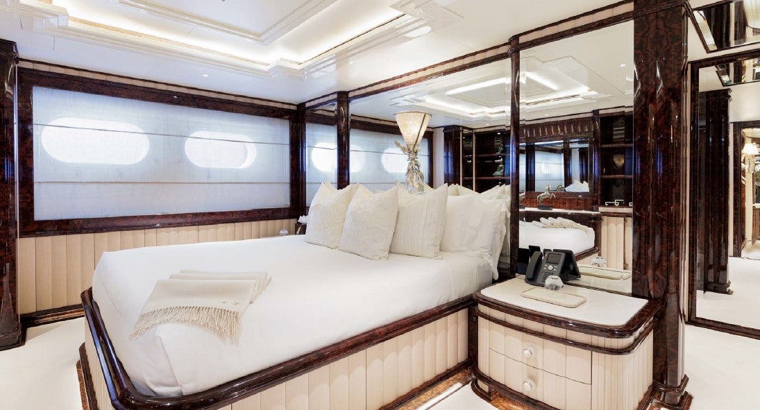a bed with a white bed aboard LIONESS V Yacht for Sale