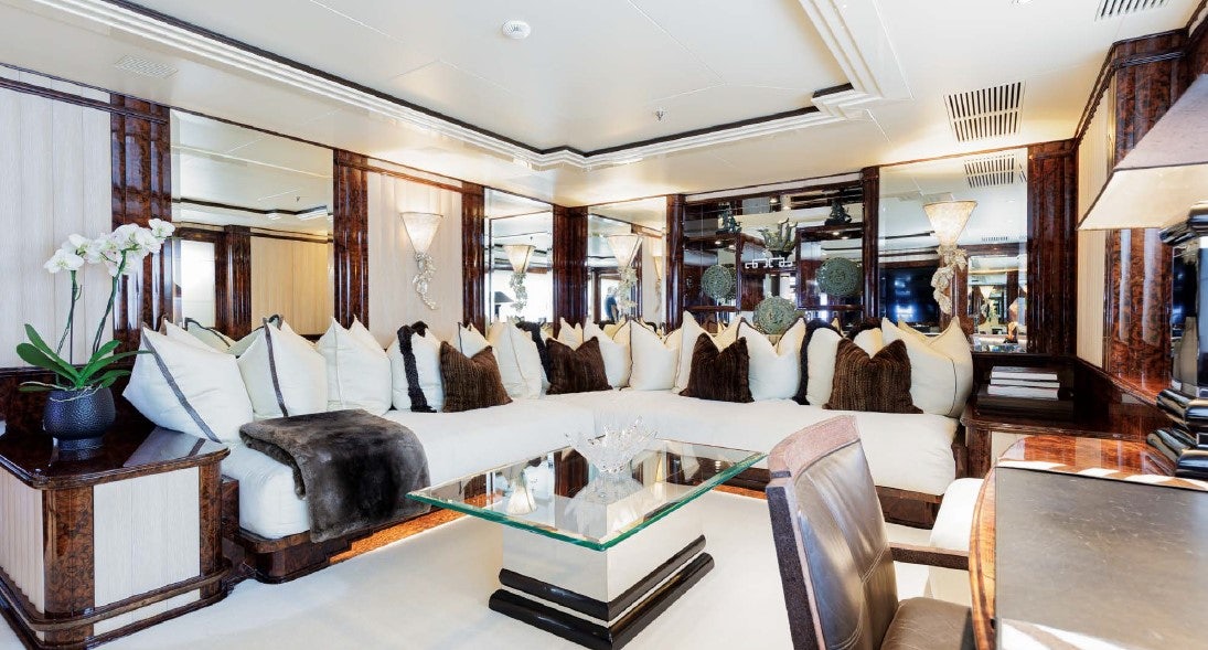 a large living room with a large mirror aboard LIONESS V Yacht for Sale