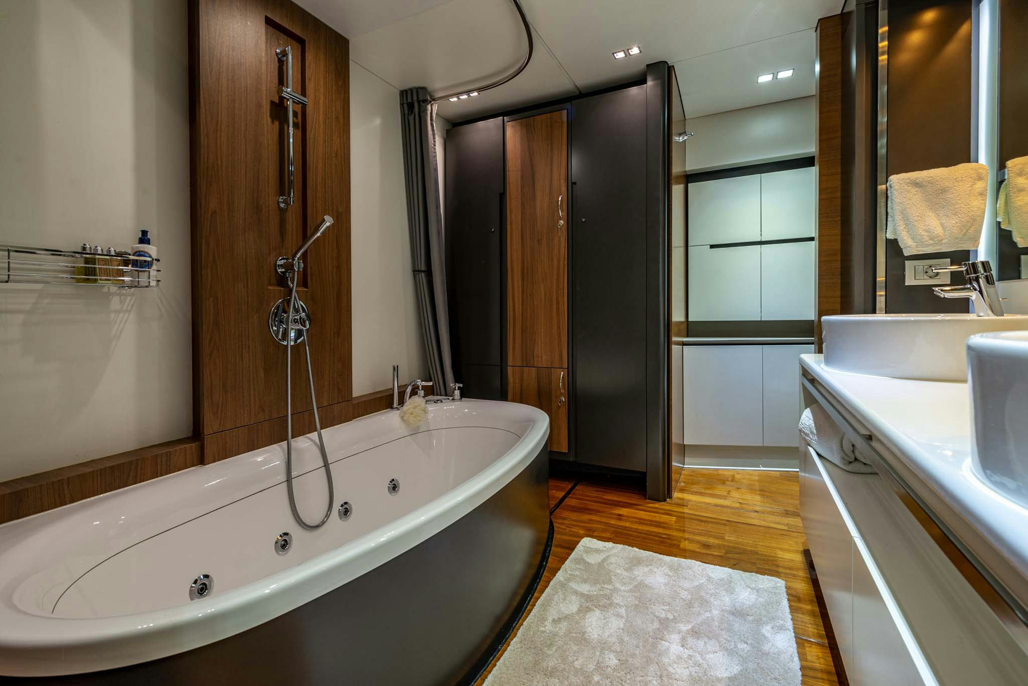 a bathroom with a tub sink and shower unit aboard QUANTUM Yacht for Charter