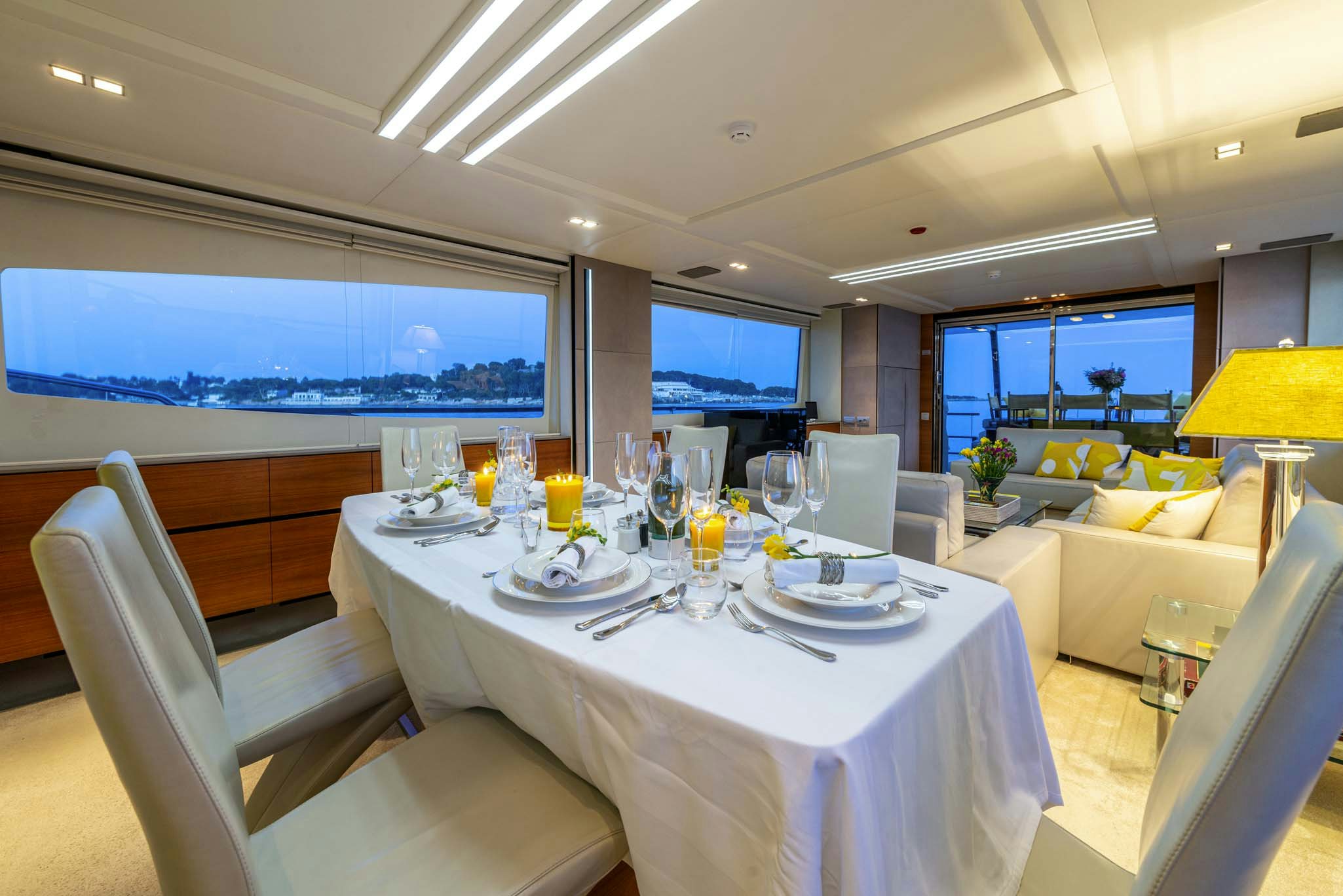 a room with a table chairs and a large screen aboard QUANTUM Yacht for Charter