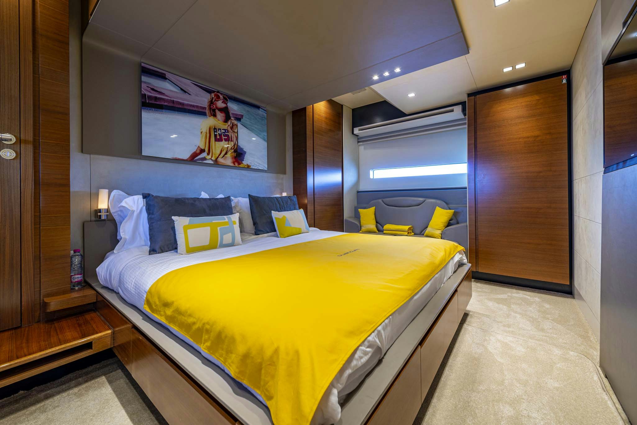 a bedroom with a bed and a tv on the wall aboard QUANTUM Yacht for Charter