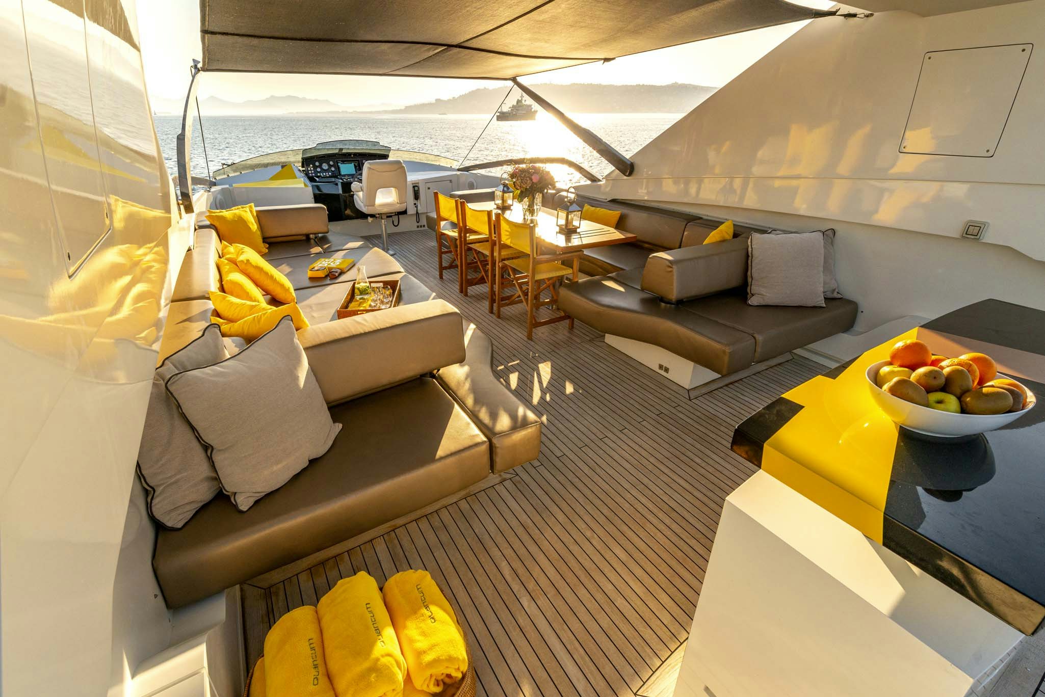 a room with a bed and a table with food on it aboard QUANTUM Yacht for Charter