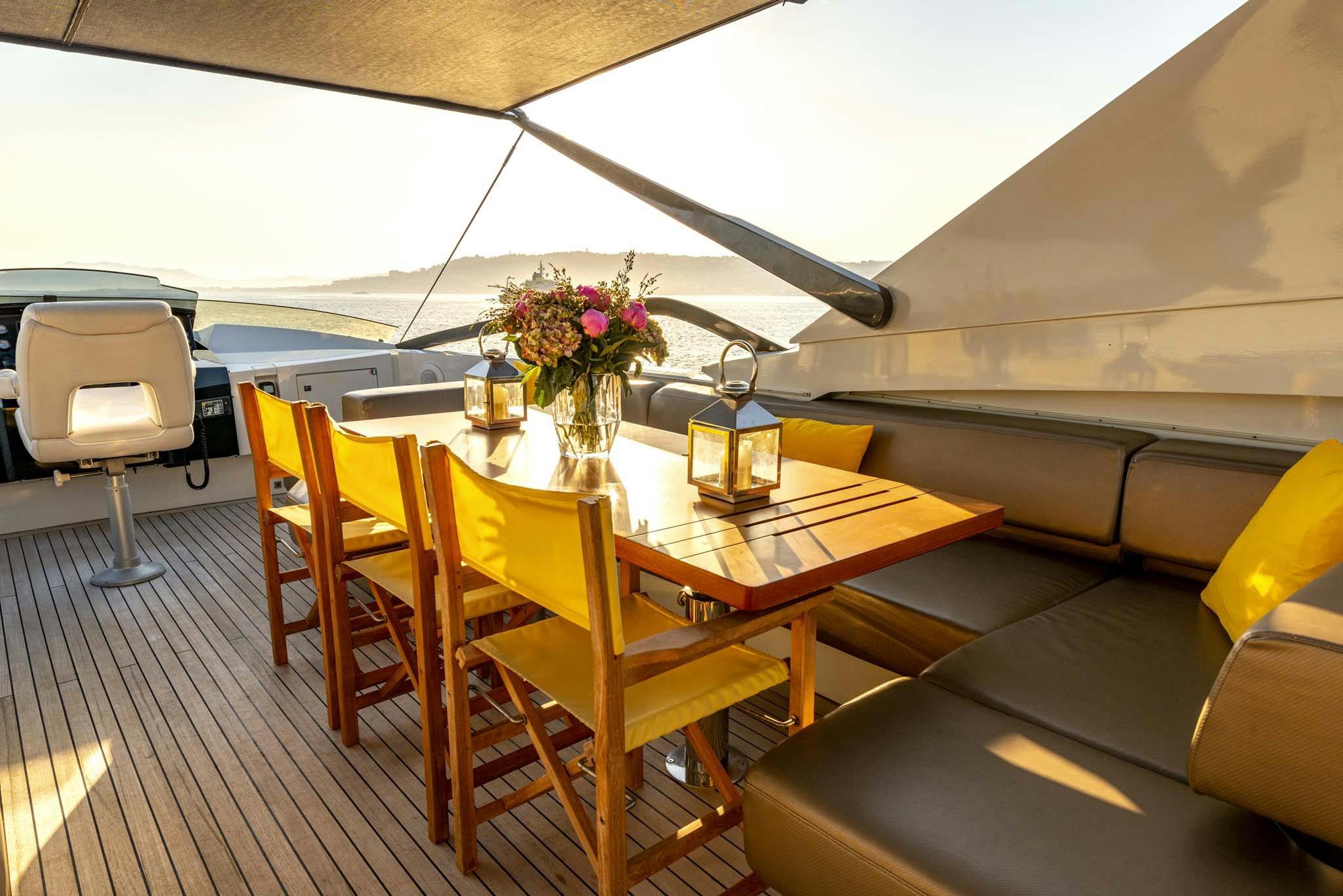 a dining table with chairs aboard QUANTUM Yacht for Charter