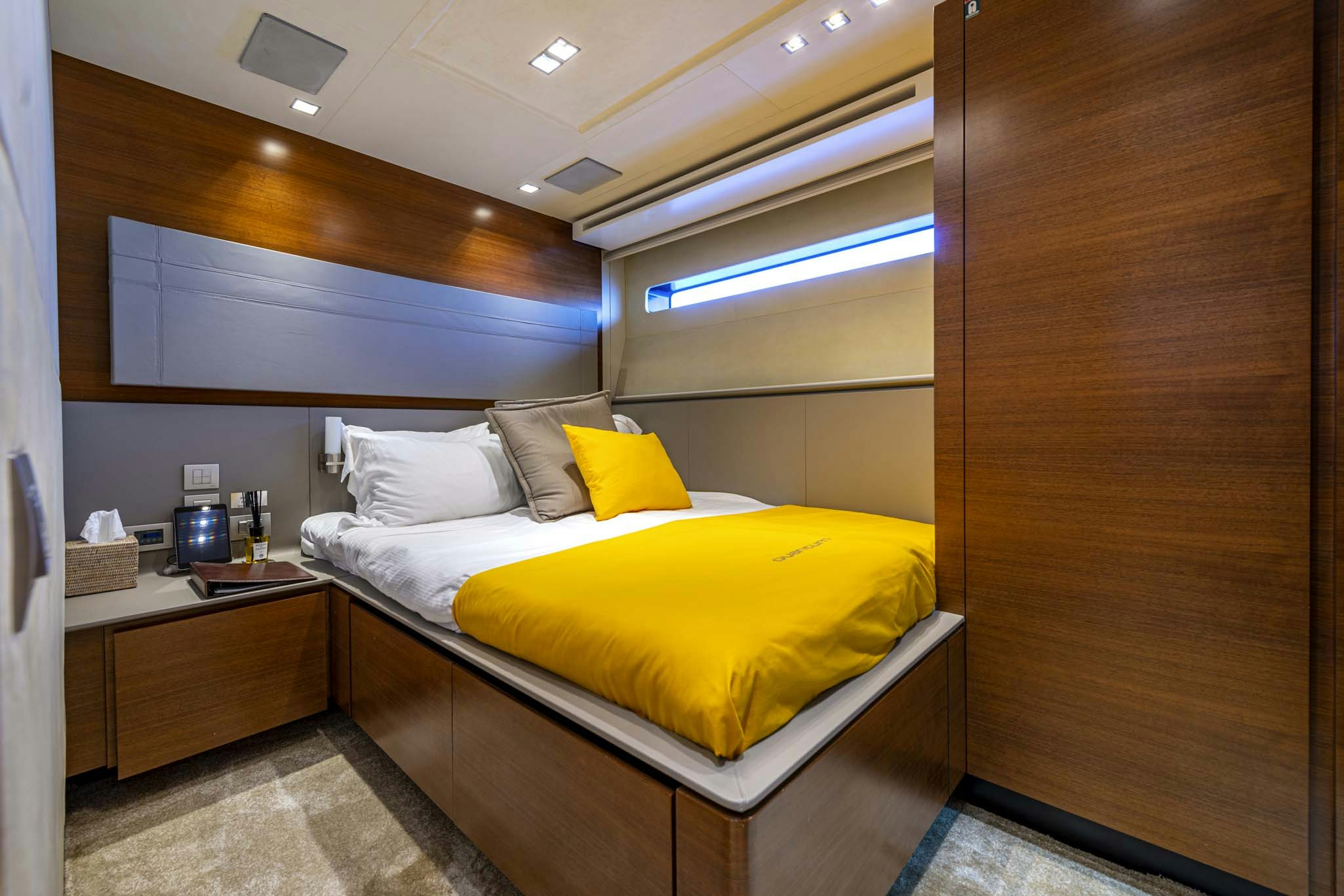 a room with a bed and a wood wall aboard QUANTUM Yacht for Charter