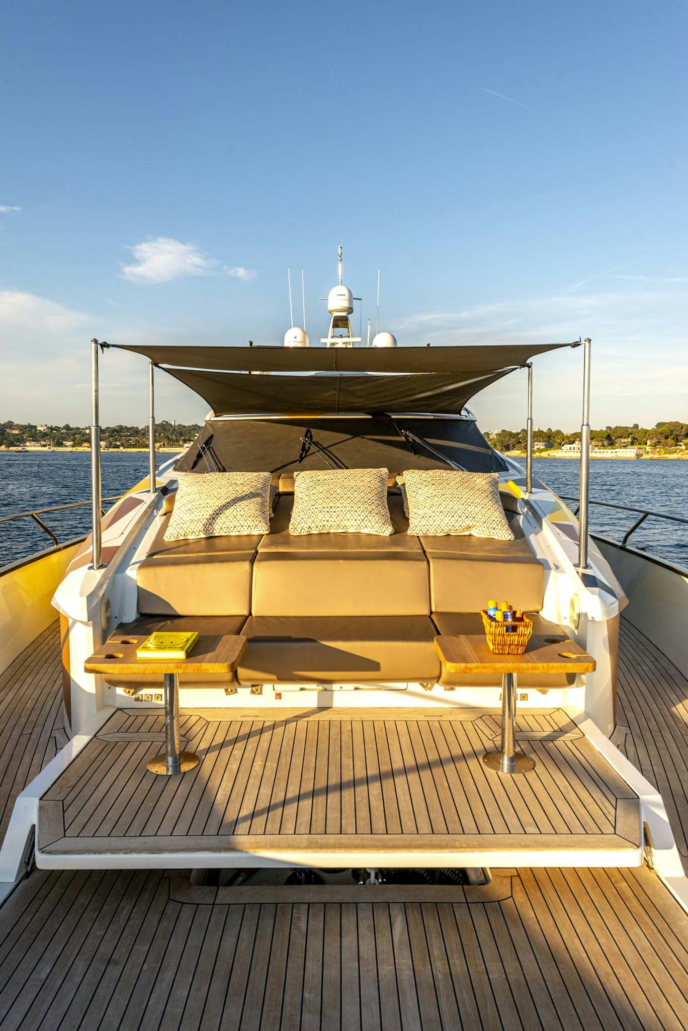 a deck with a large boat on it and a large building in the background aboard QUANTUM Yacht for Charter