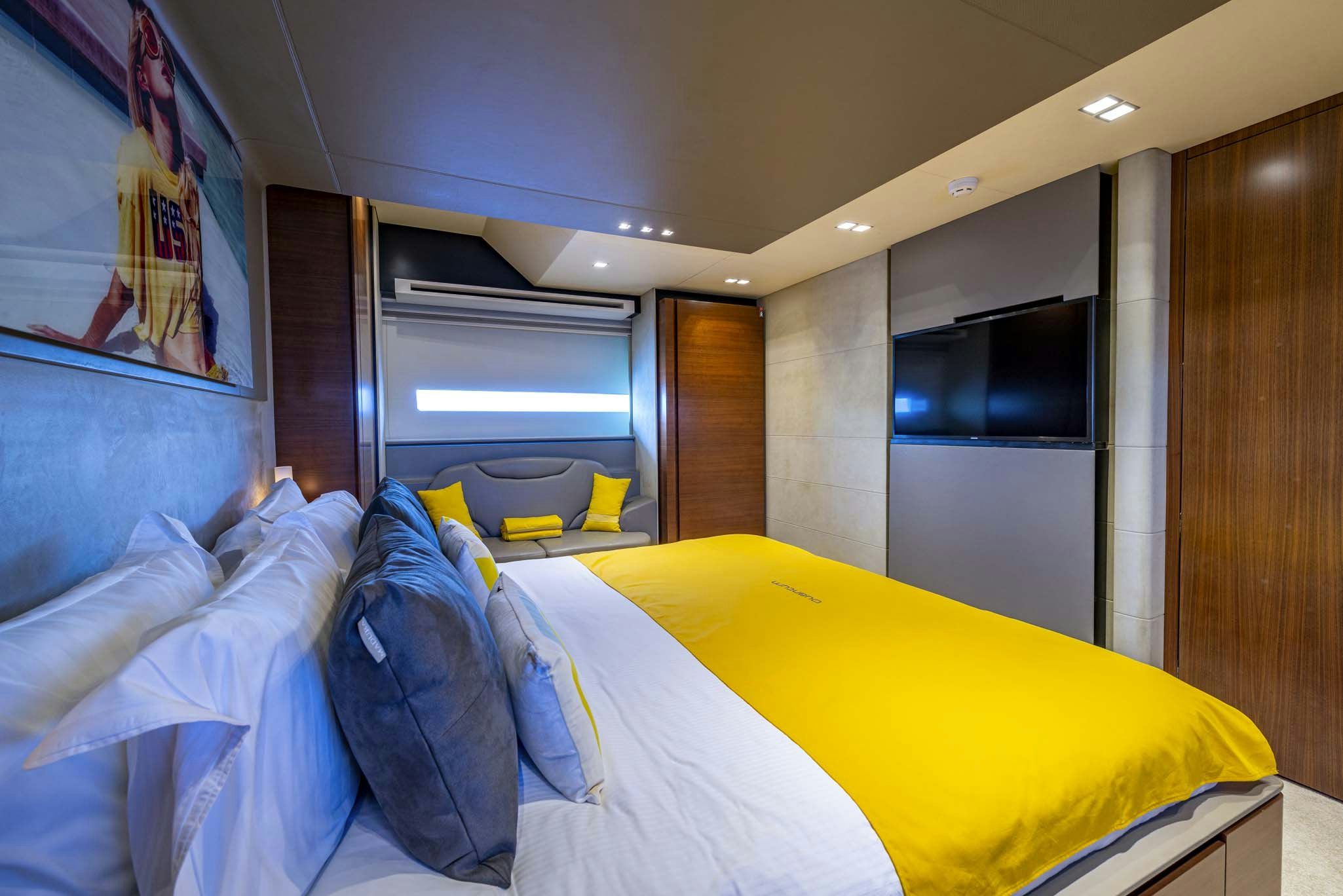 a bedroom with a bed and a tv aboard QUANTUM Yacht for Sale