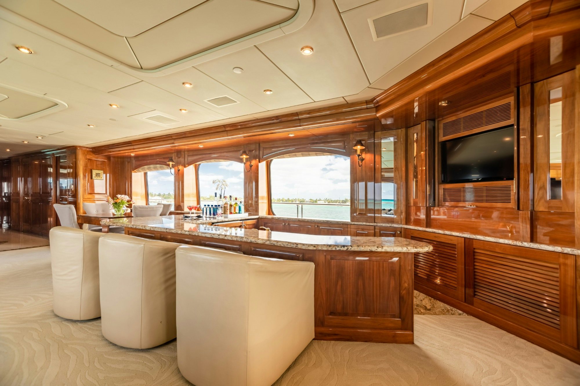 a room with a large bar and a large window aboard AMORE Yacht for Charter