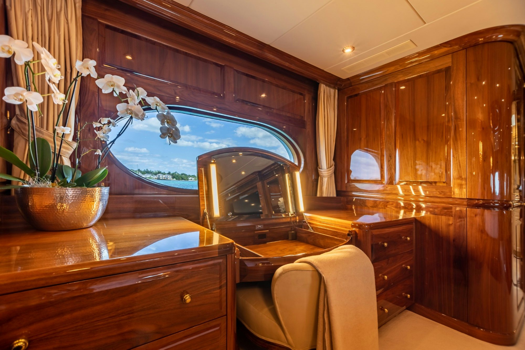a room with a mirror and furniture aboard AMORE Yacht for Charter