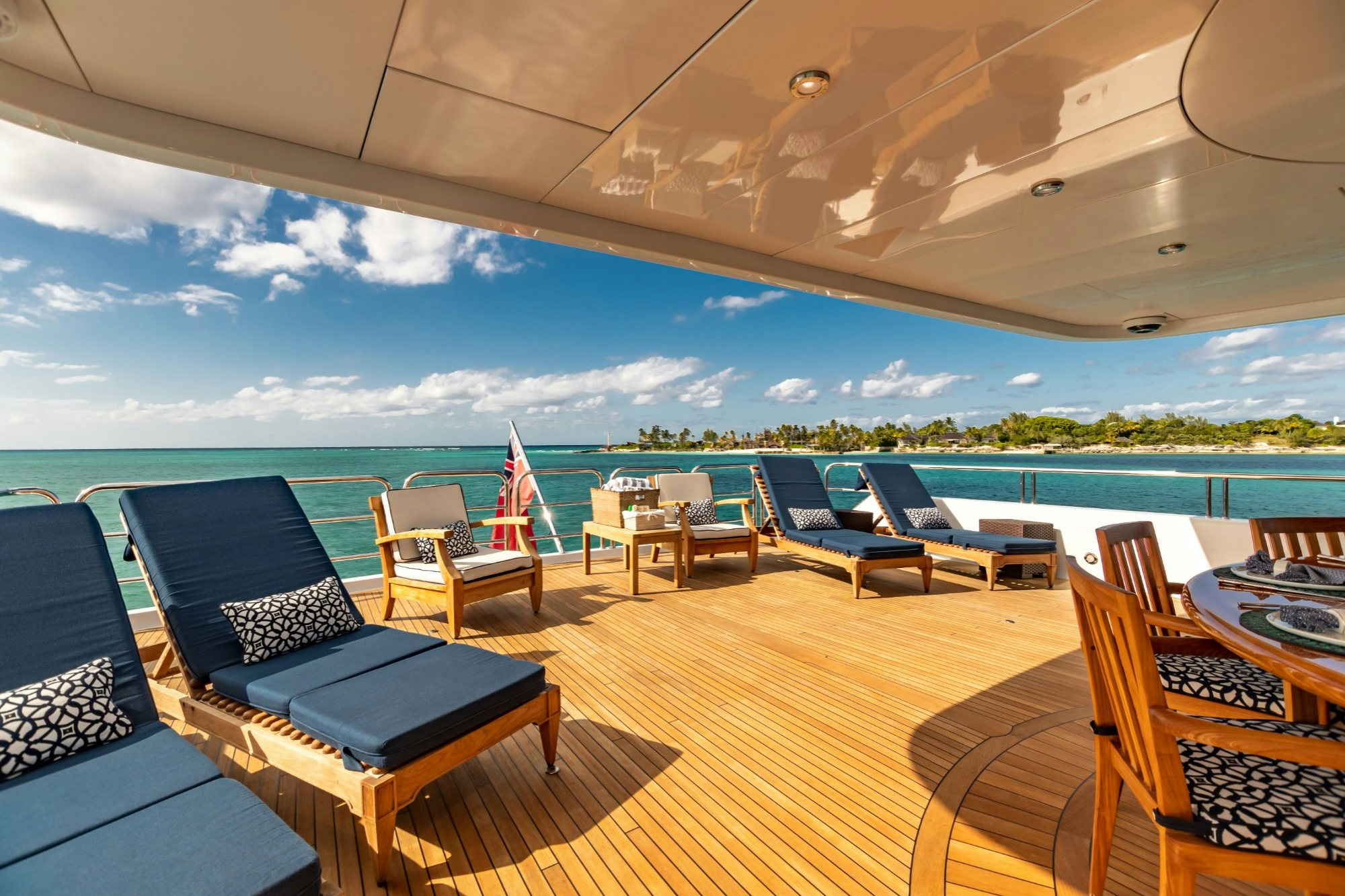 a lounge area on a deck overlooking a large pool aboard AMORE Yacht for Charter