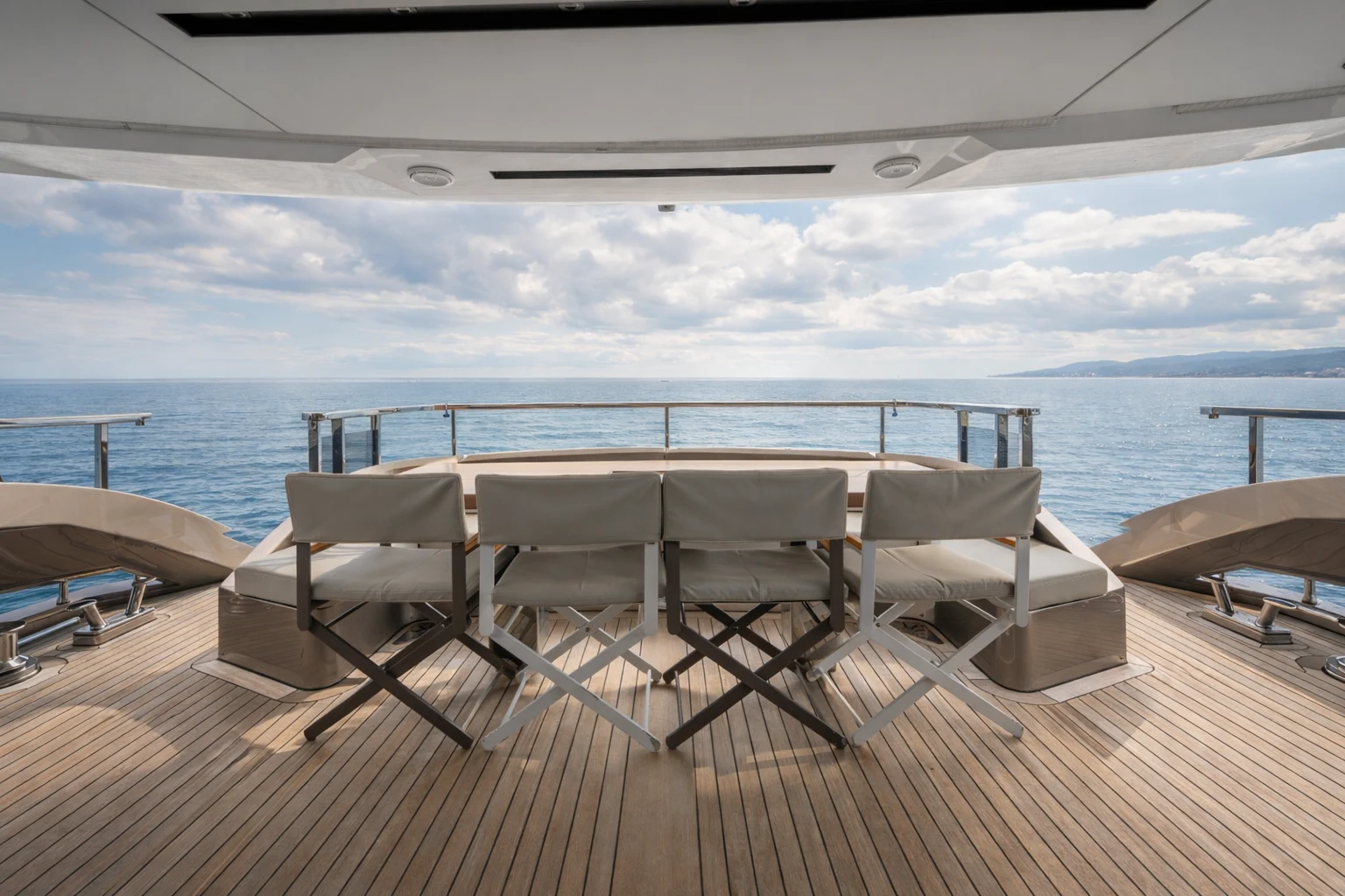 a deck with chairs and a body of water in the background aboard ZALANKA Yacht for Sale