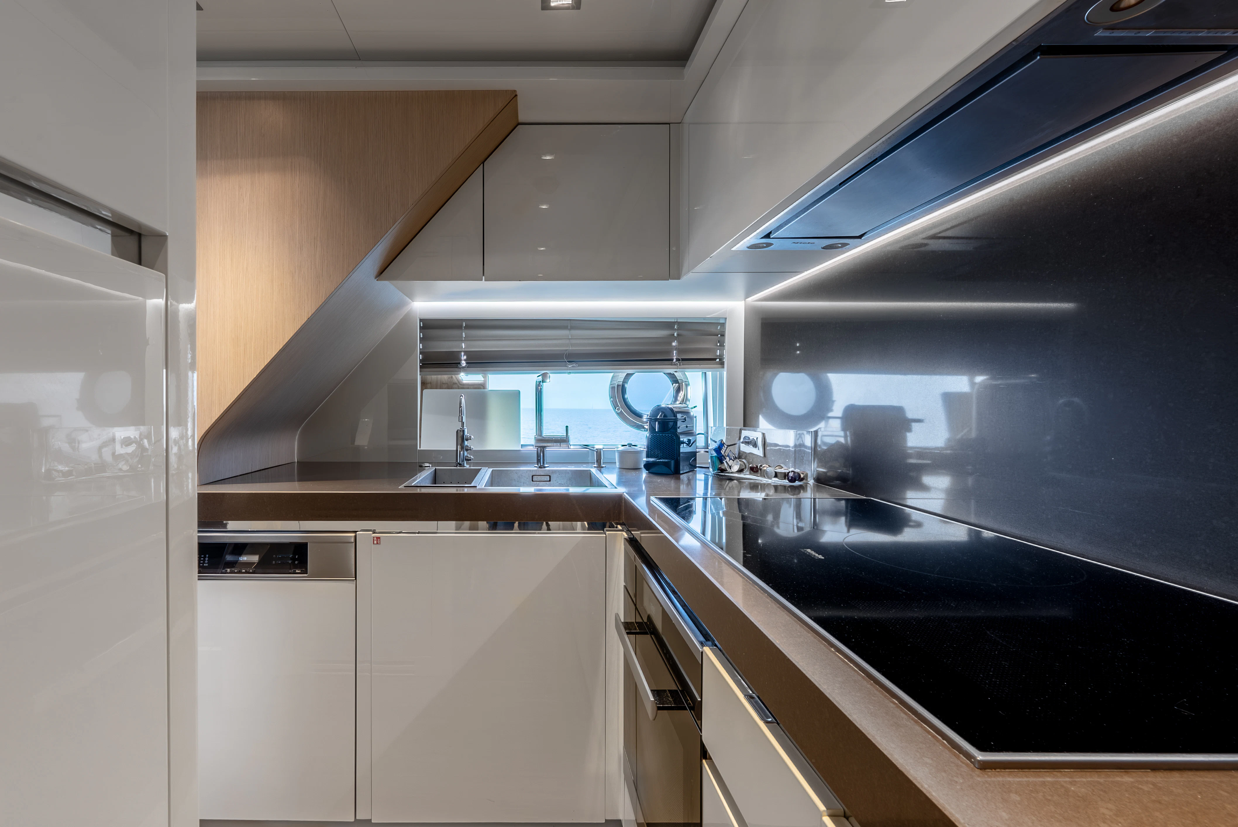 a kitchen with a large window aboard ZALANKA Yacht for Sale