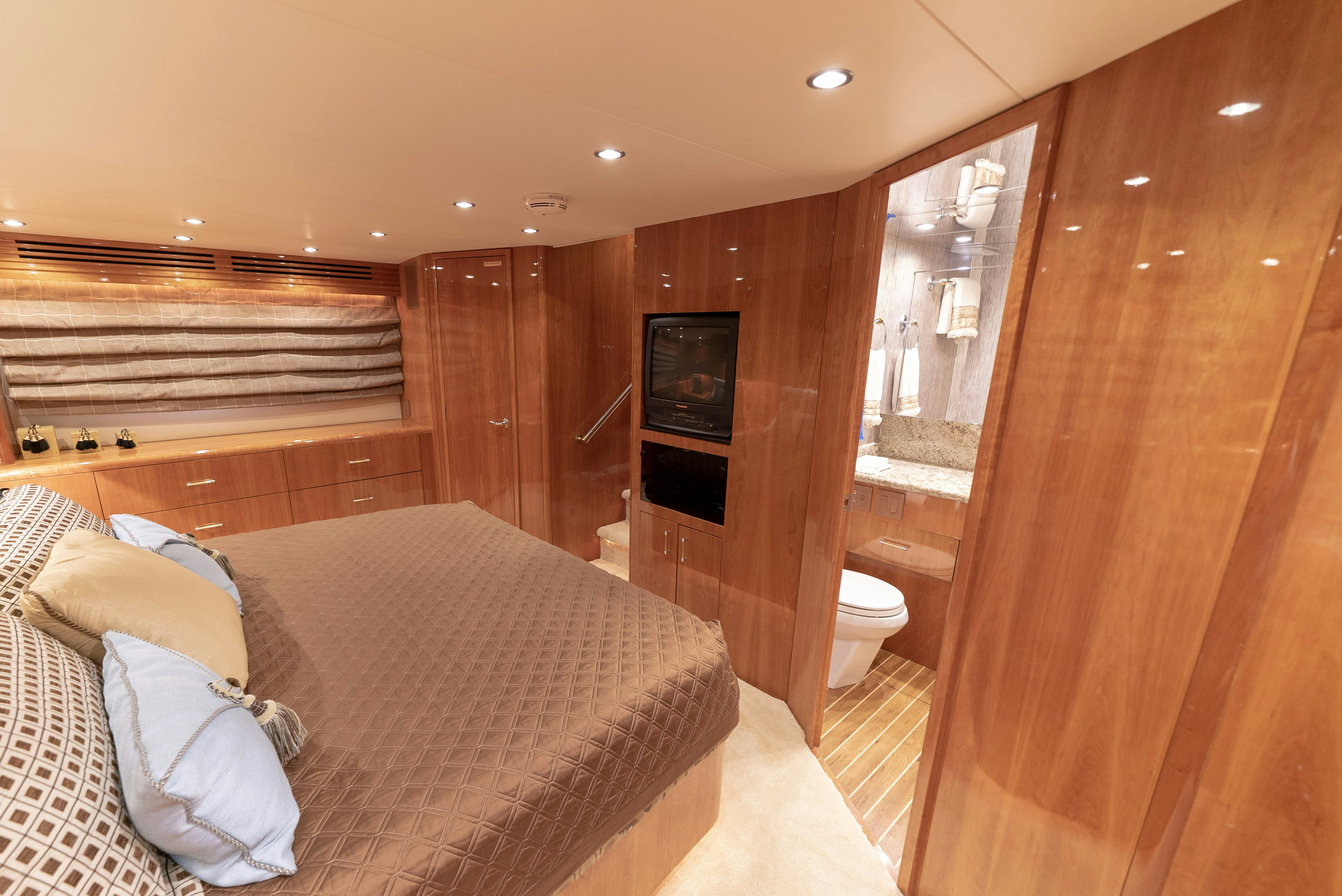 a bedroom with a bed and a television aboard SONORA Yacht for Sale