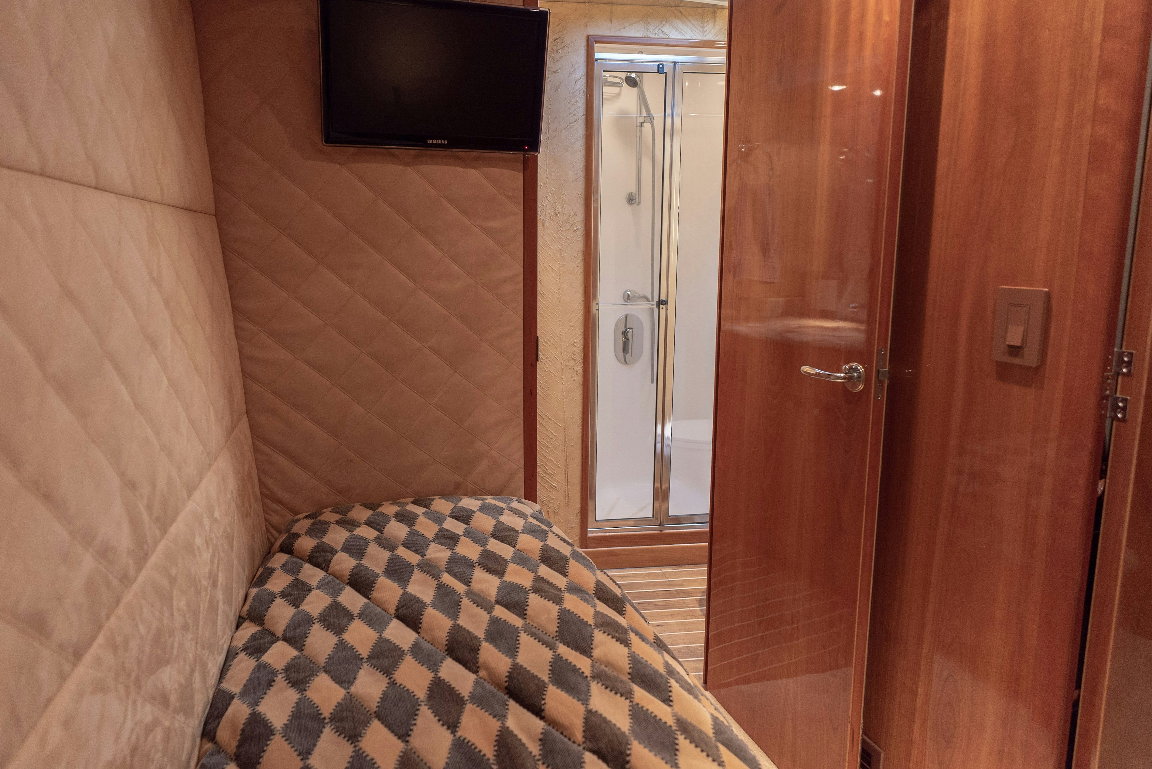 a room with a bed and a television aboard SONORA Yacht for Sale