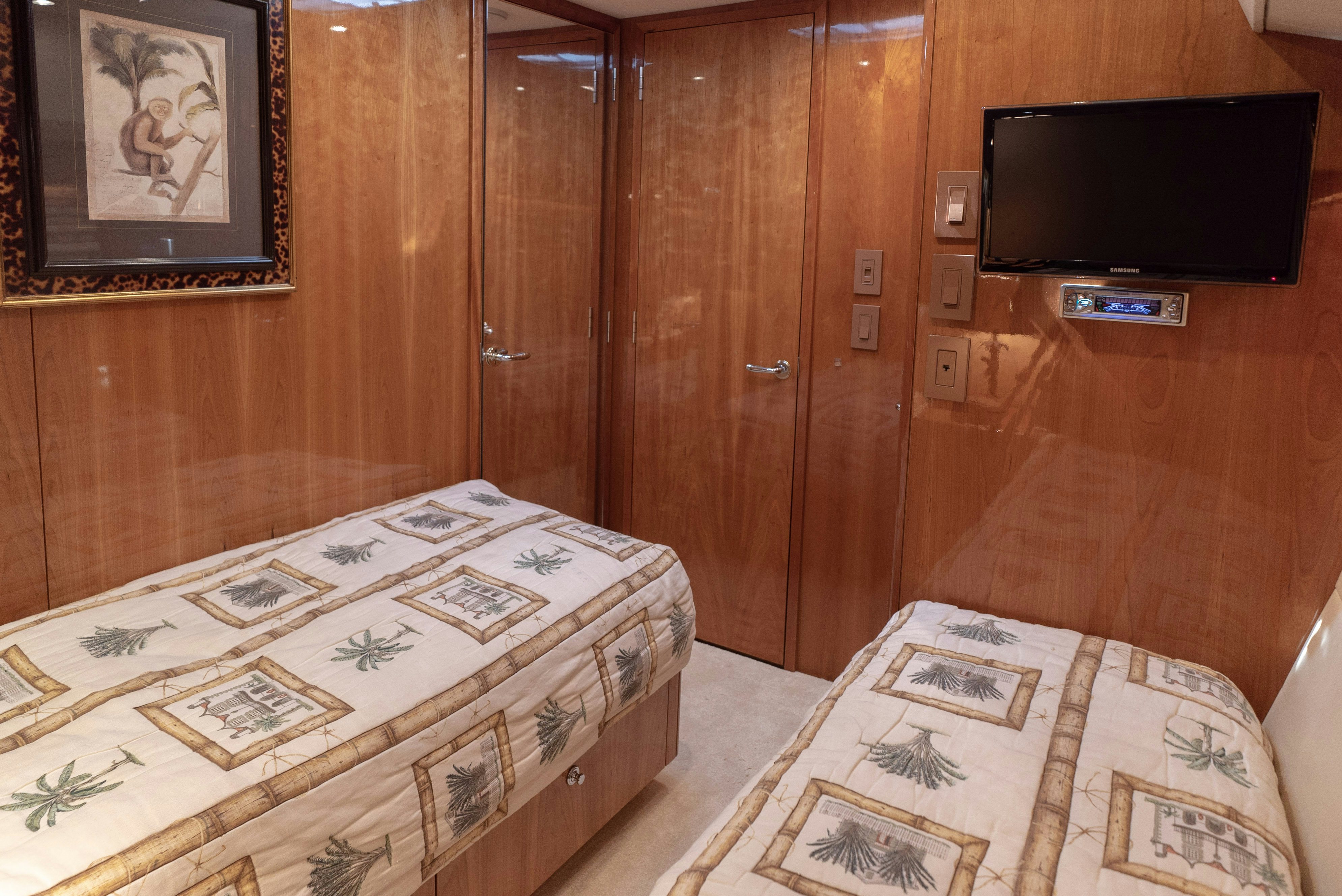 a room with a tv and a bed aboard SONORA Yacht for Sale