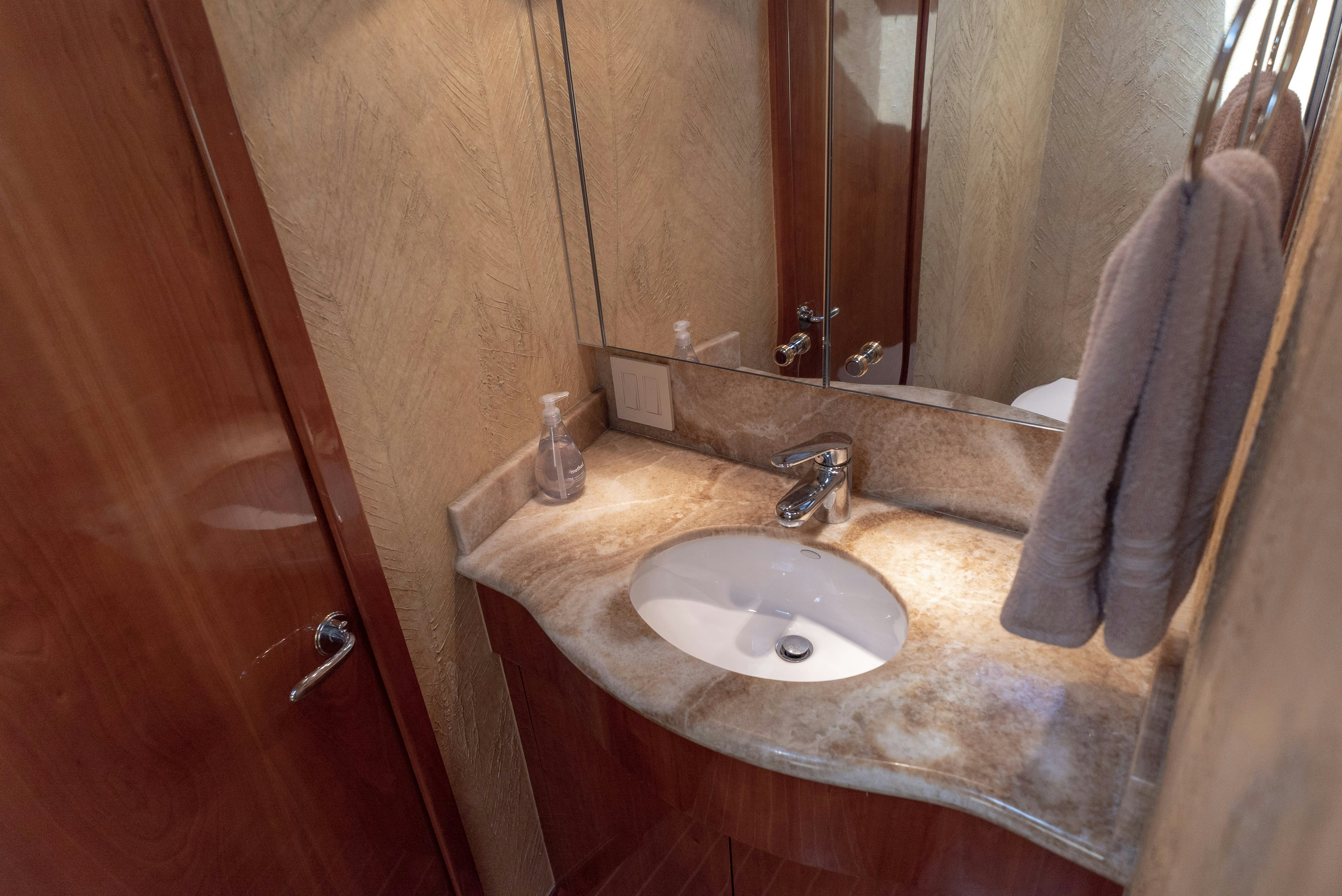 a bathroom with a sink and a mirror aboard SONORA Yacht for Sale