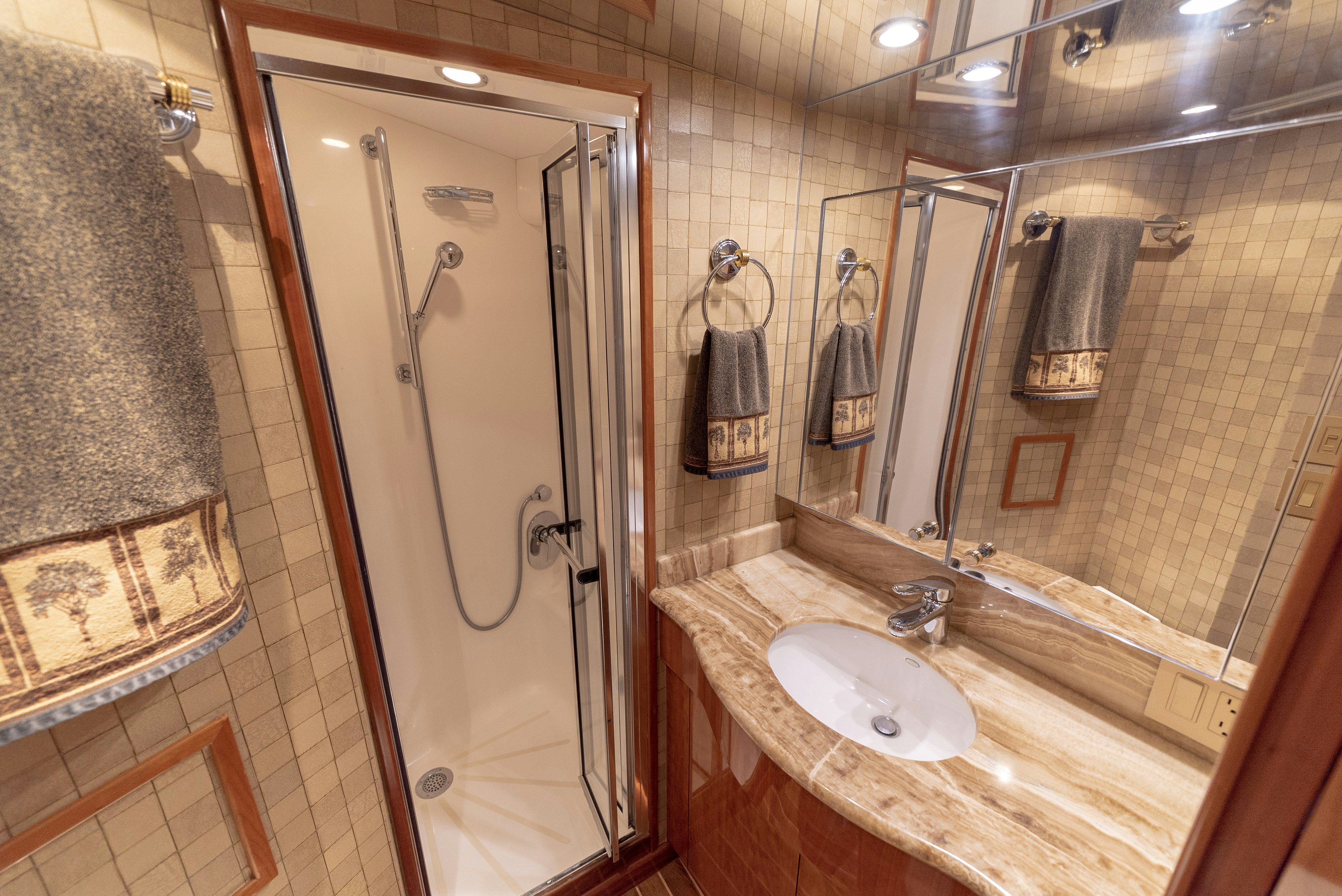 a bathroom with a shower unit and sink aboard SONORA Yacht for Sale
