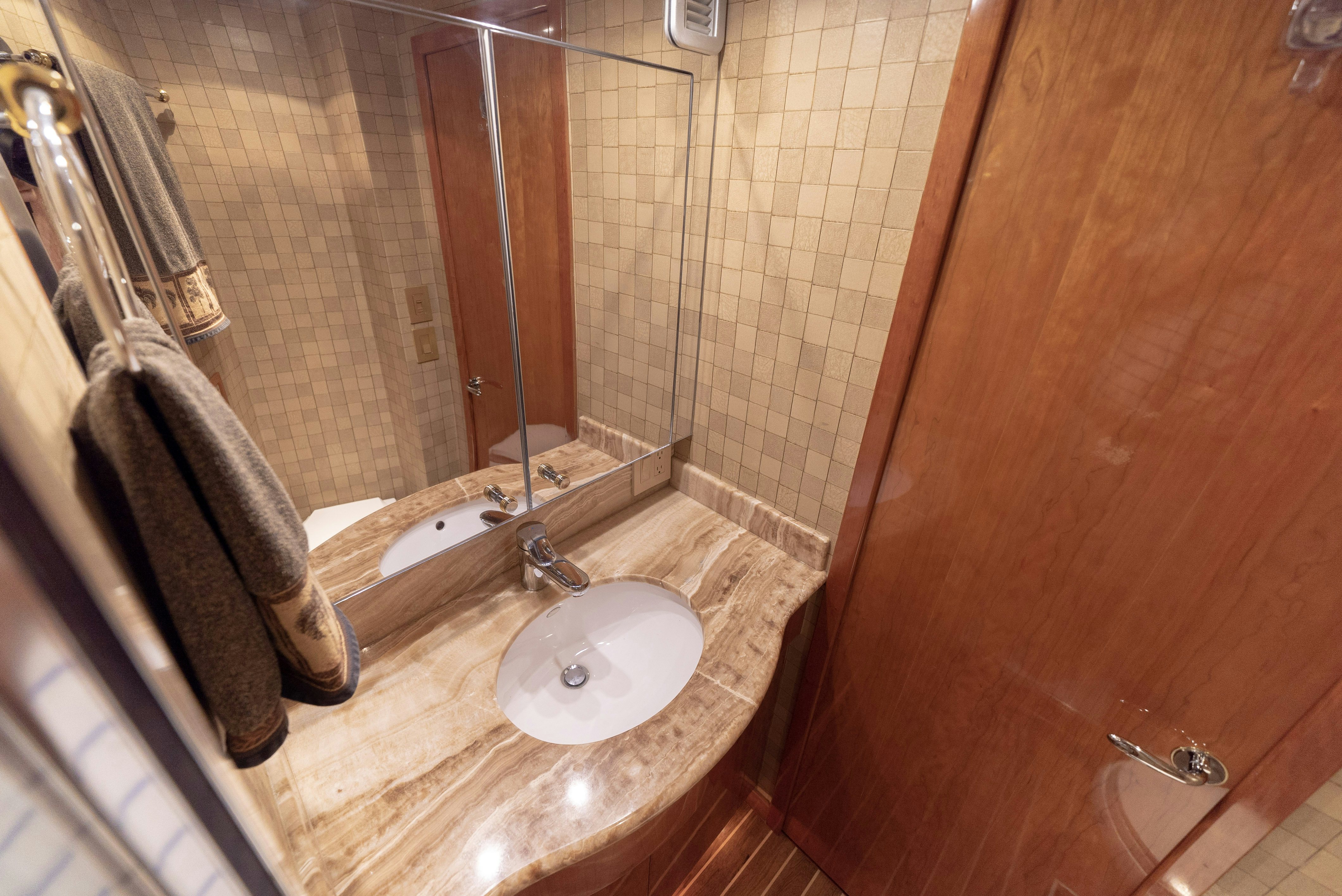 a bathroom with a sink and a mirror aboard SONORA Yacht for Sale